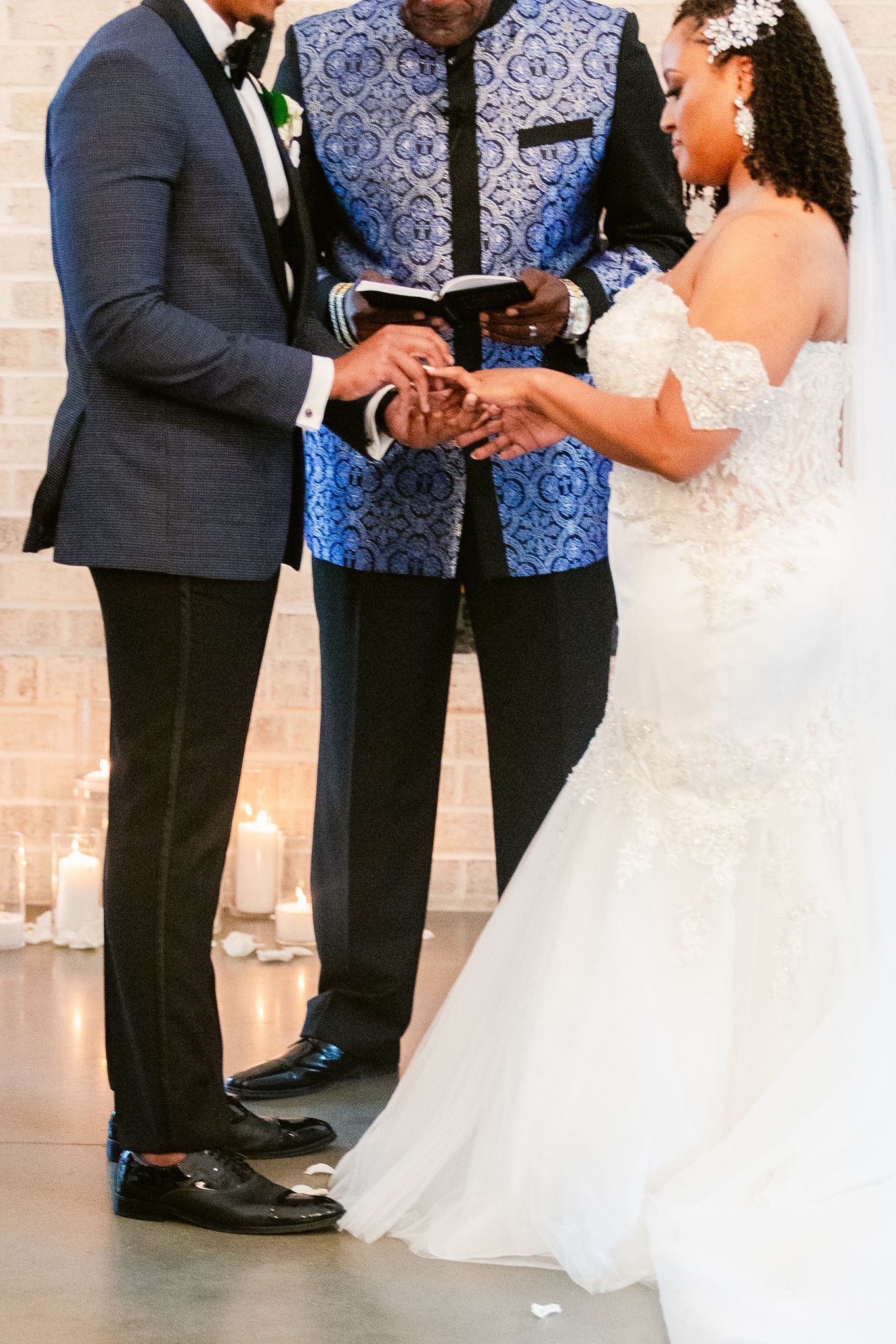 Wedding ceremony participants stand together during an intimate indoor service.