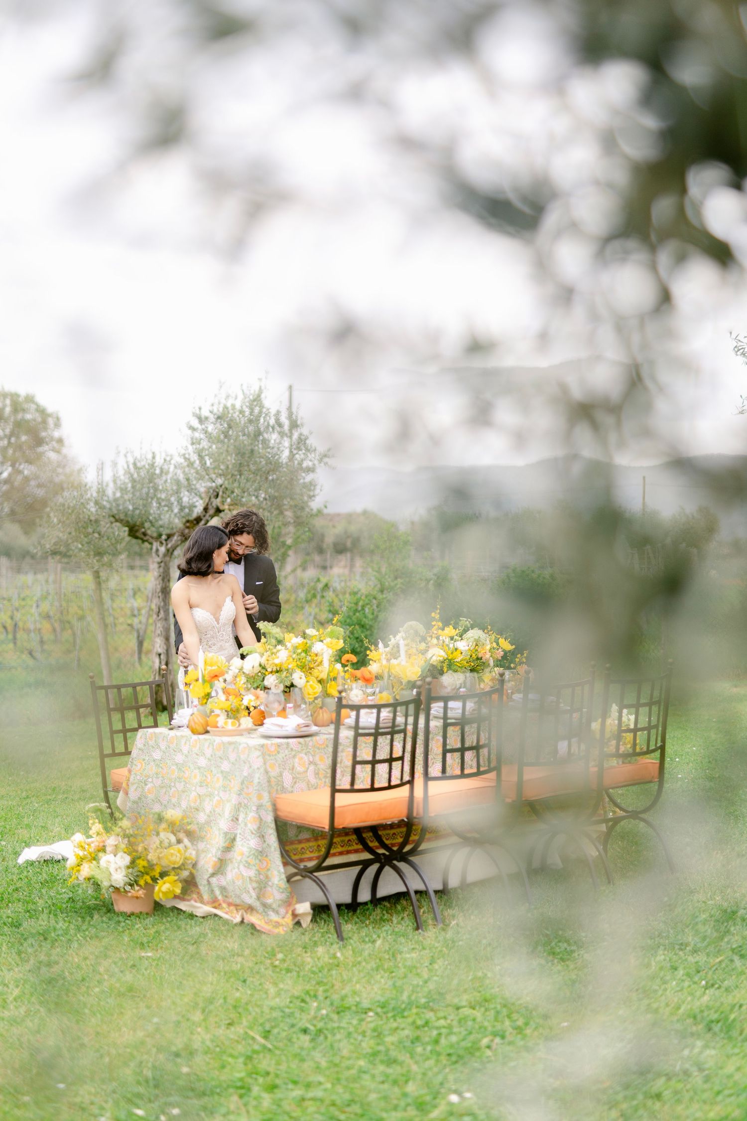 A romantic outdoor table setting with yellow flowers and vintage decor in a dreamy garden atmosphere.