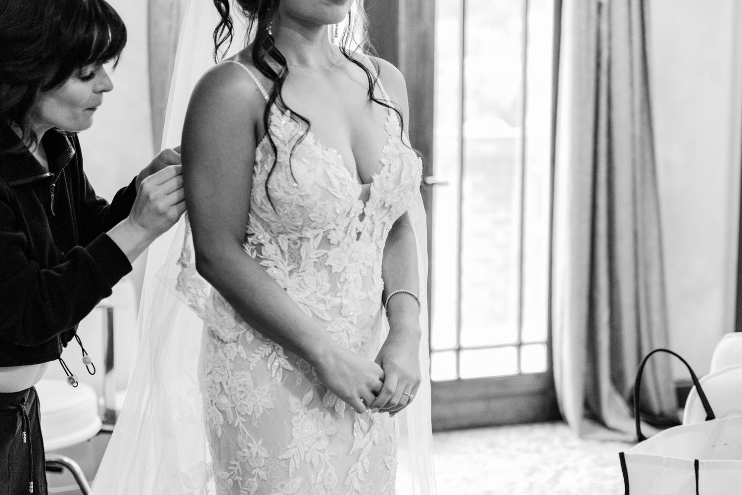 A series of black and white photos showing preparations for a wedding ceremony with elegant formal attire.