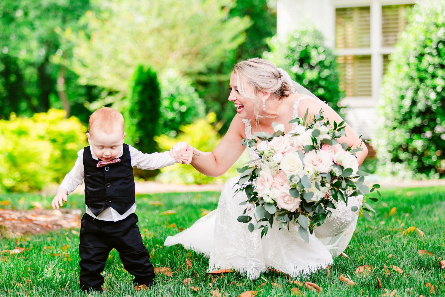 Wedding couple shares romantic moments in a lush garden setting with delicate floral arrangements and greenery.