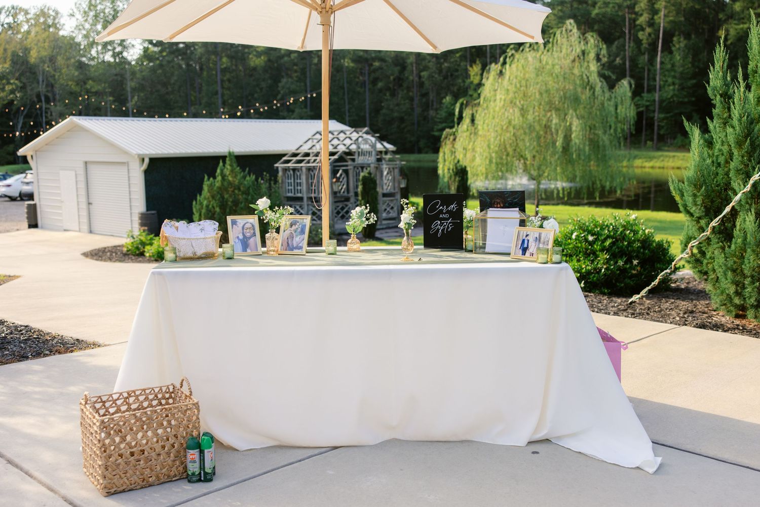 A white umbrella and outdoor seating arrangement with decorative elements in a garden setting.