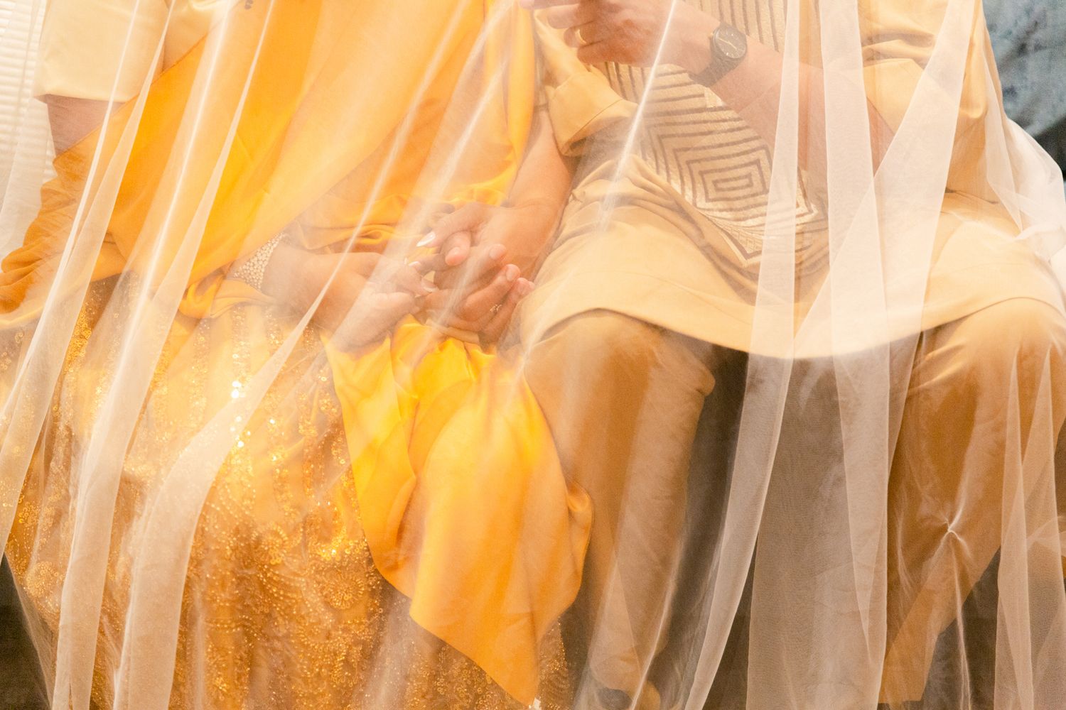 Elegant table settings with orange and white tulle decorations at a formal event.