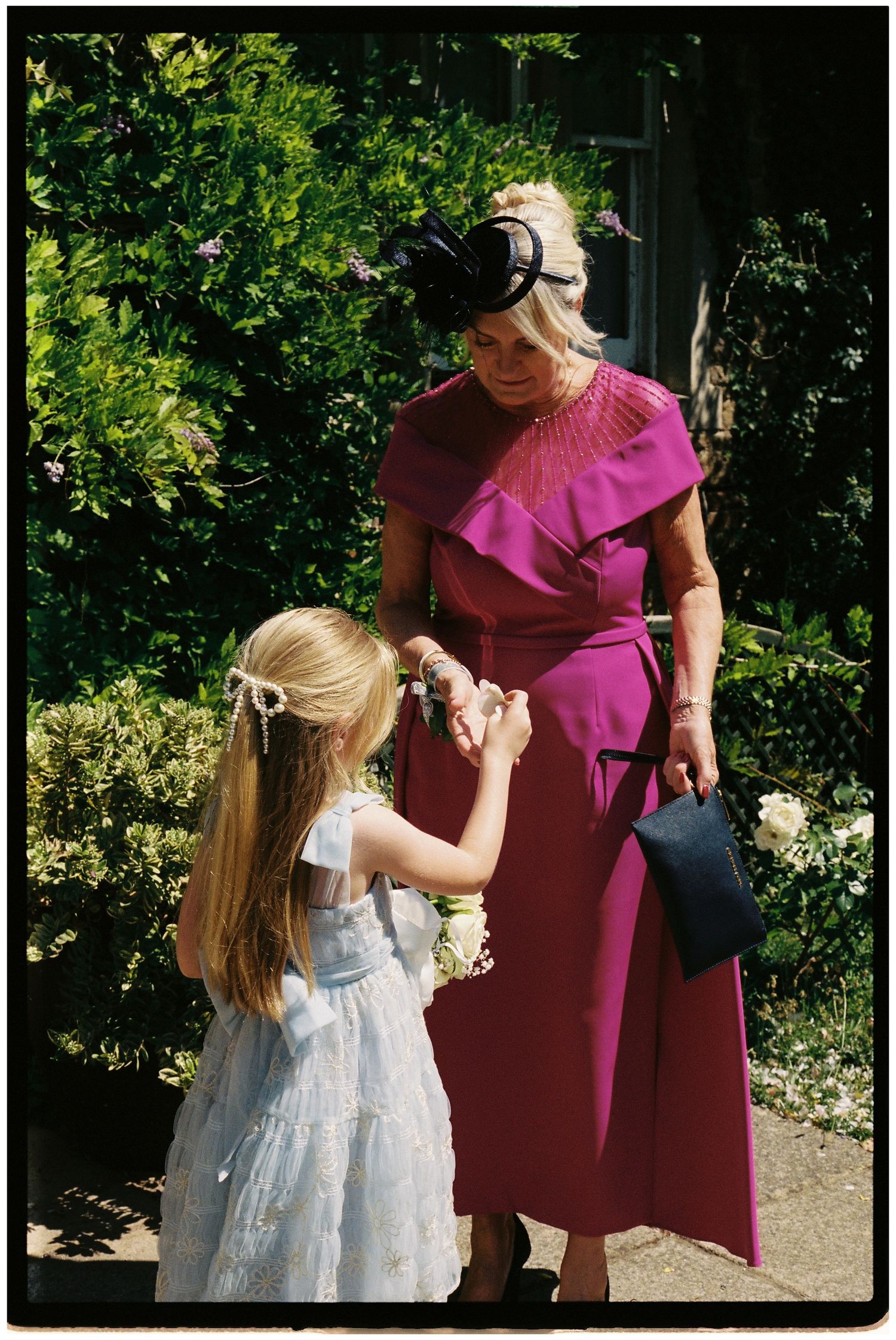 Flower girl handing out confetti on 35mm film.