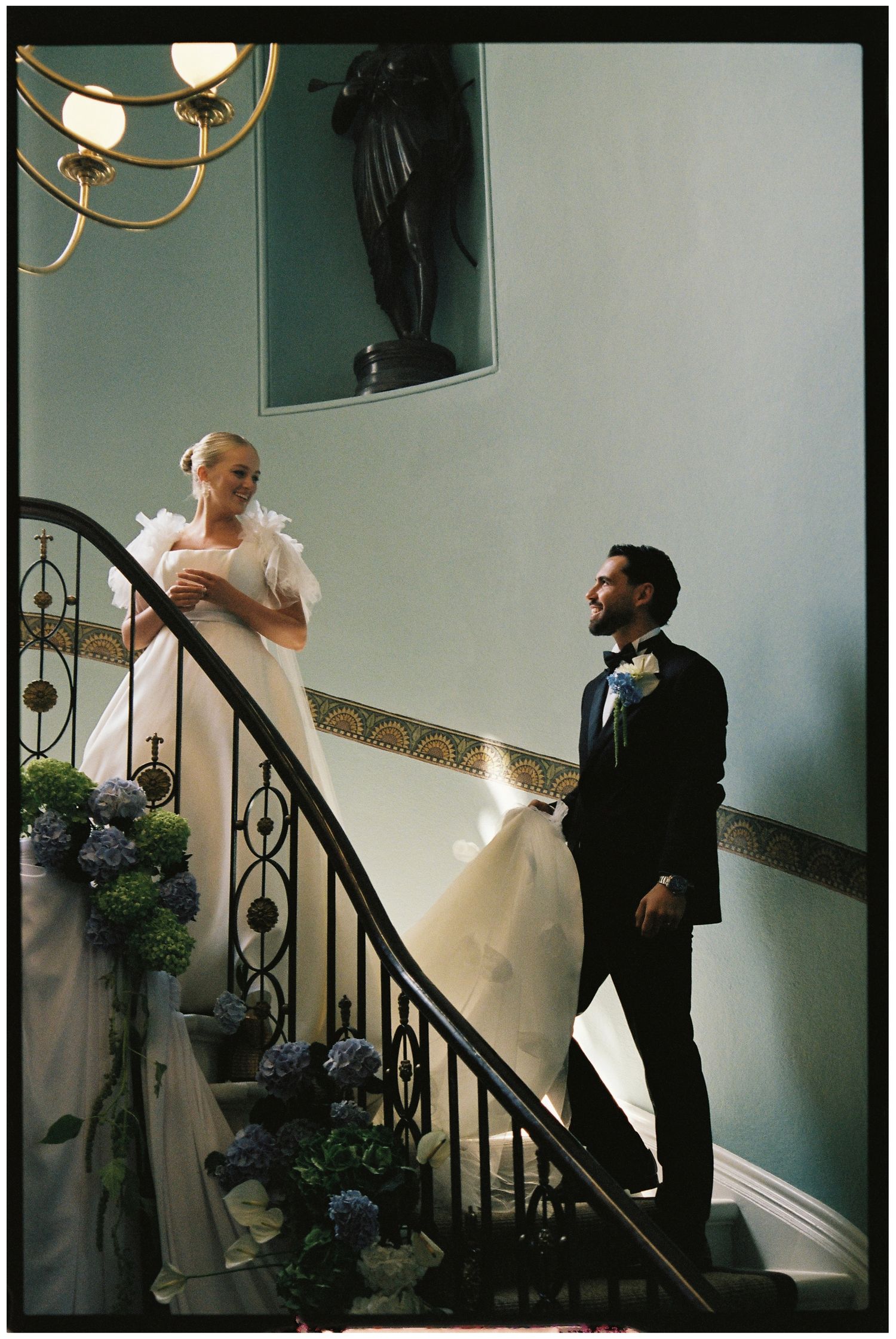 Bride and groom walking down the stairs at Henlade house on 35mm film.