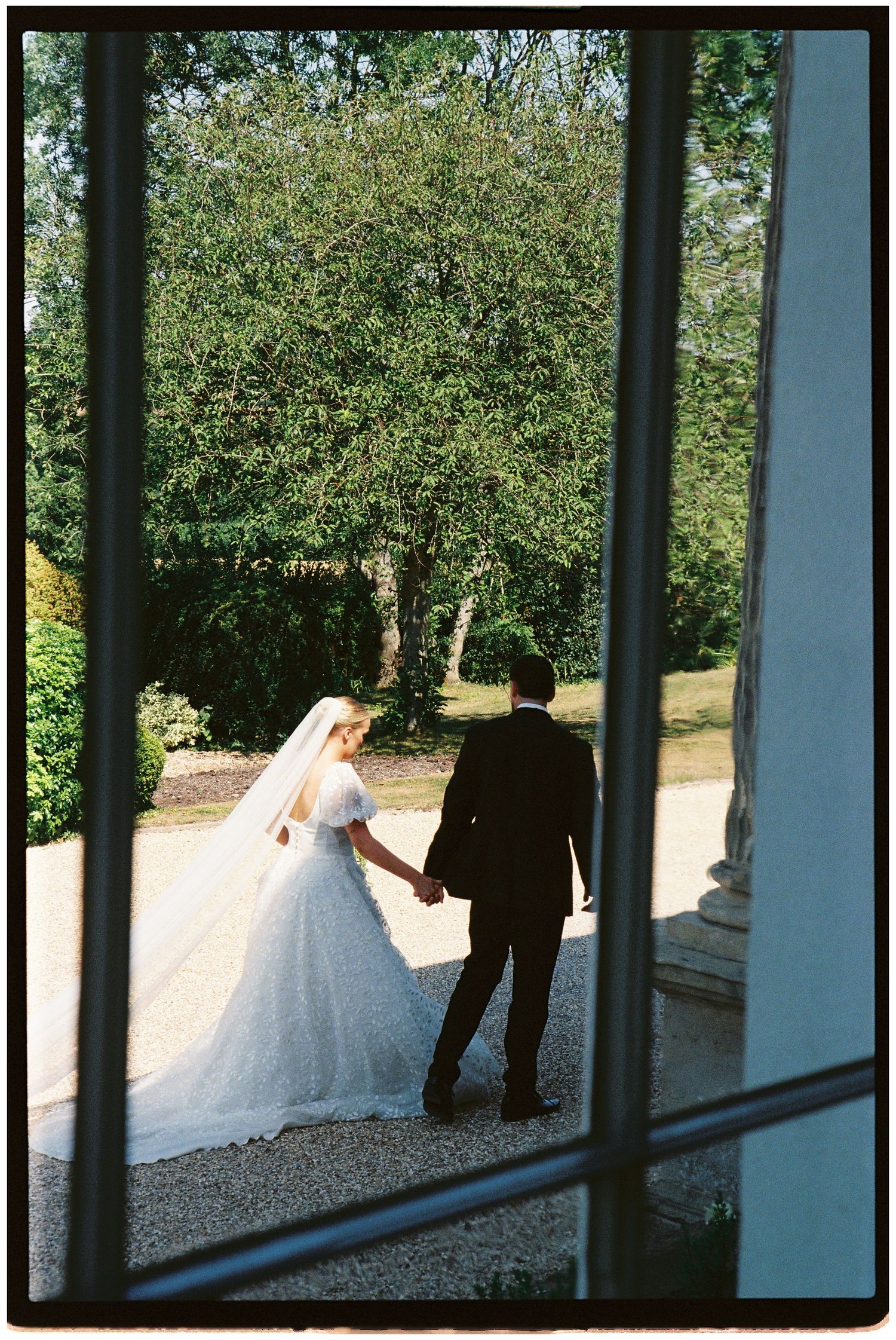 A quick shot of the bride and groom through the window at Henlade House on 35mm film.