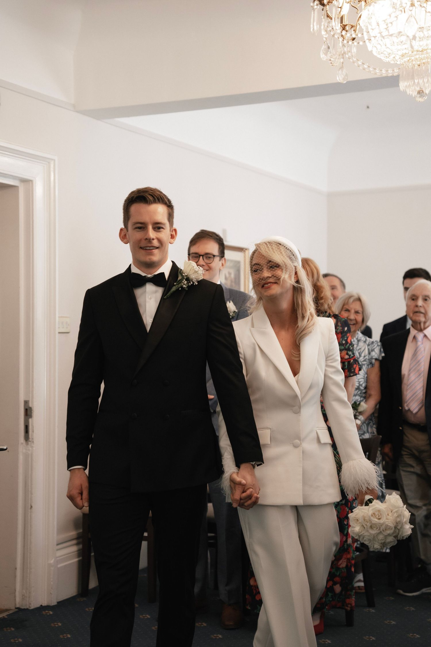 Bride and groom walking into the ceremony together. Artington House Guildford registry office