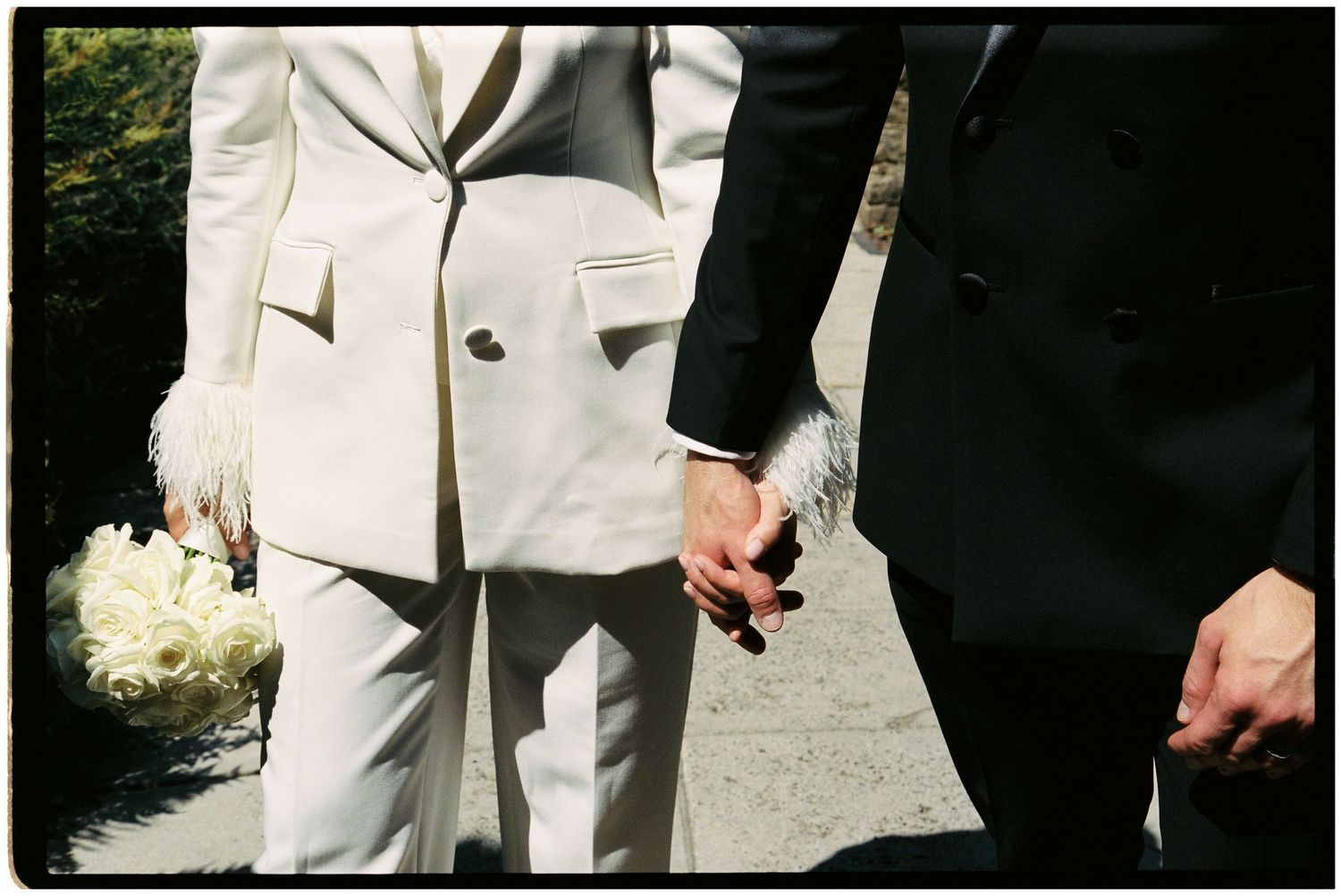 Bride and groom holding hands on 35mm film