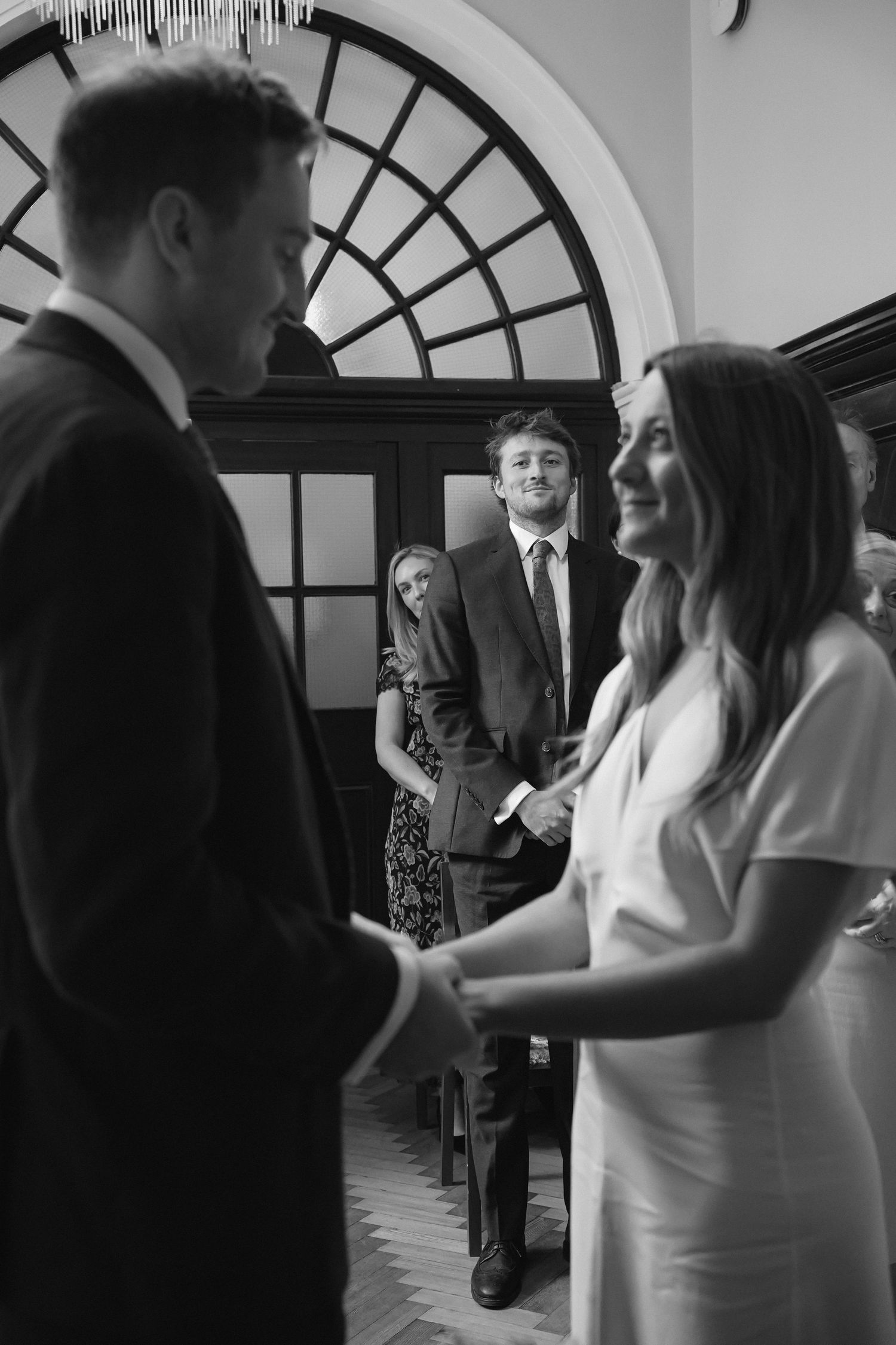 Friend looking lovingly at couple during the ceremony