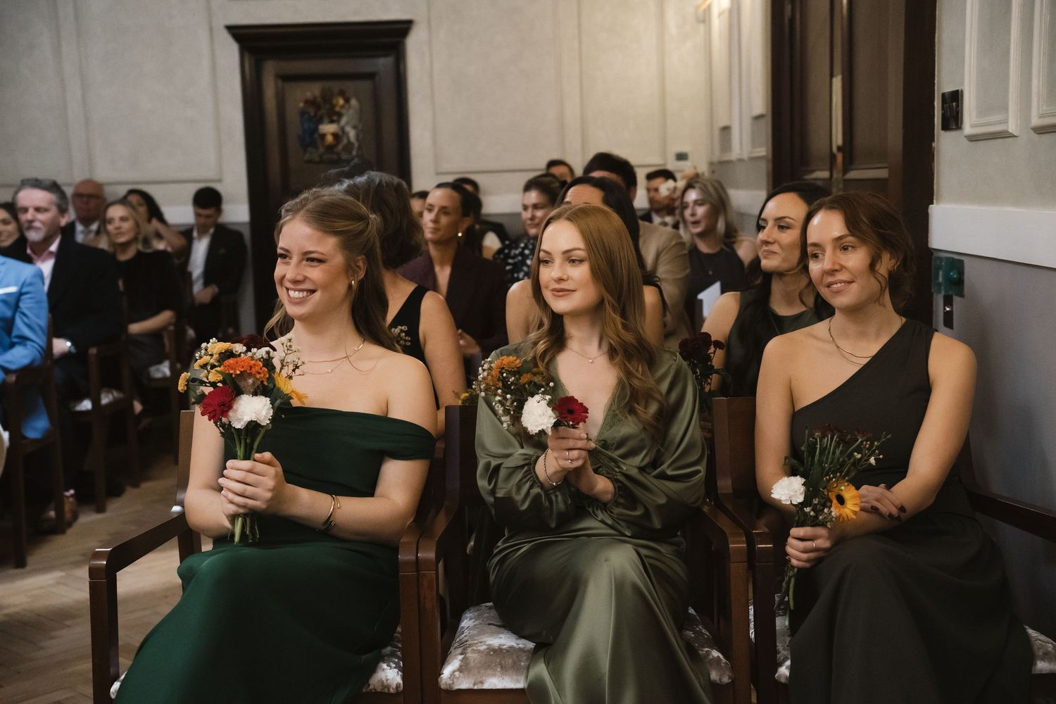 Bridesmaids looking lovingly at the couple
