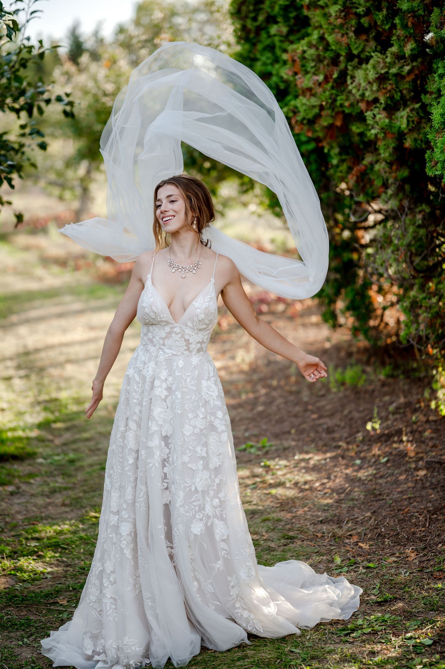 Orchard wedding, flying dress train,