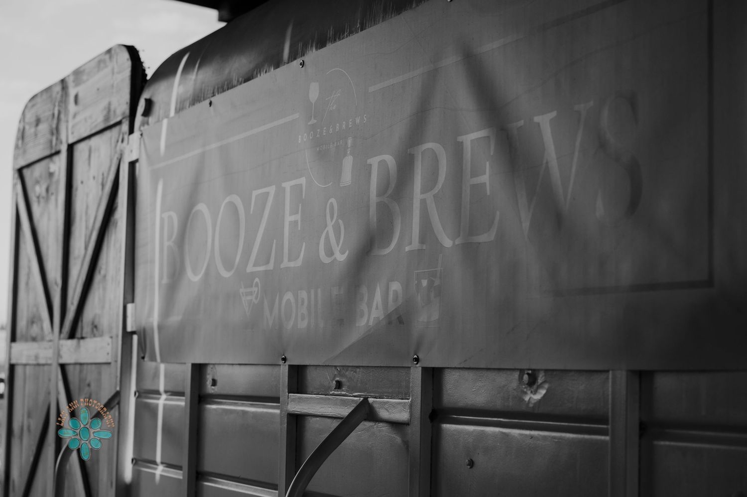 Black and white photograph of vintage text on the side of an old train car or wagon.