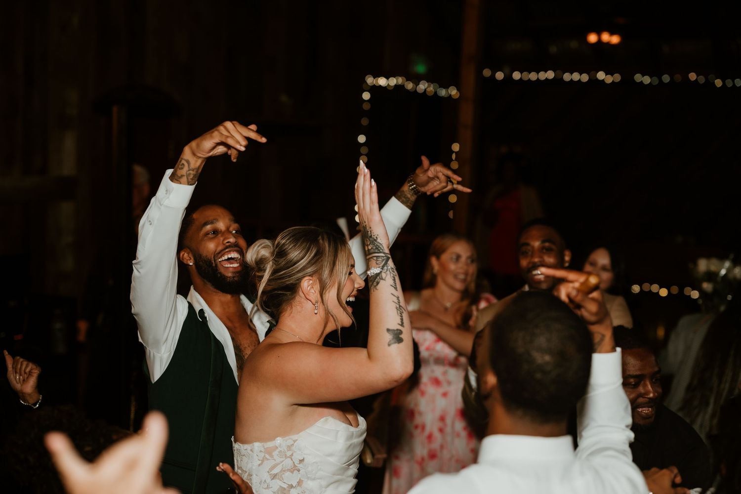 Joyful dancing and celebration during an evening wedding reception.