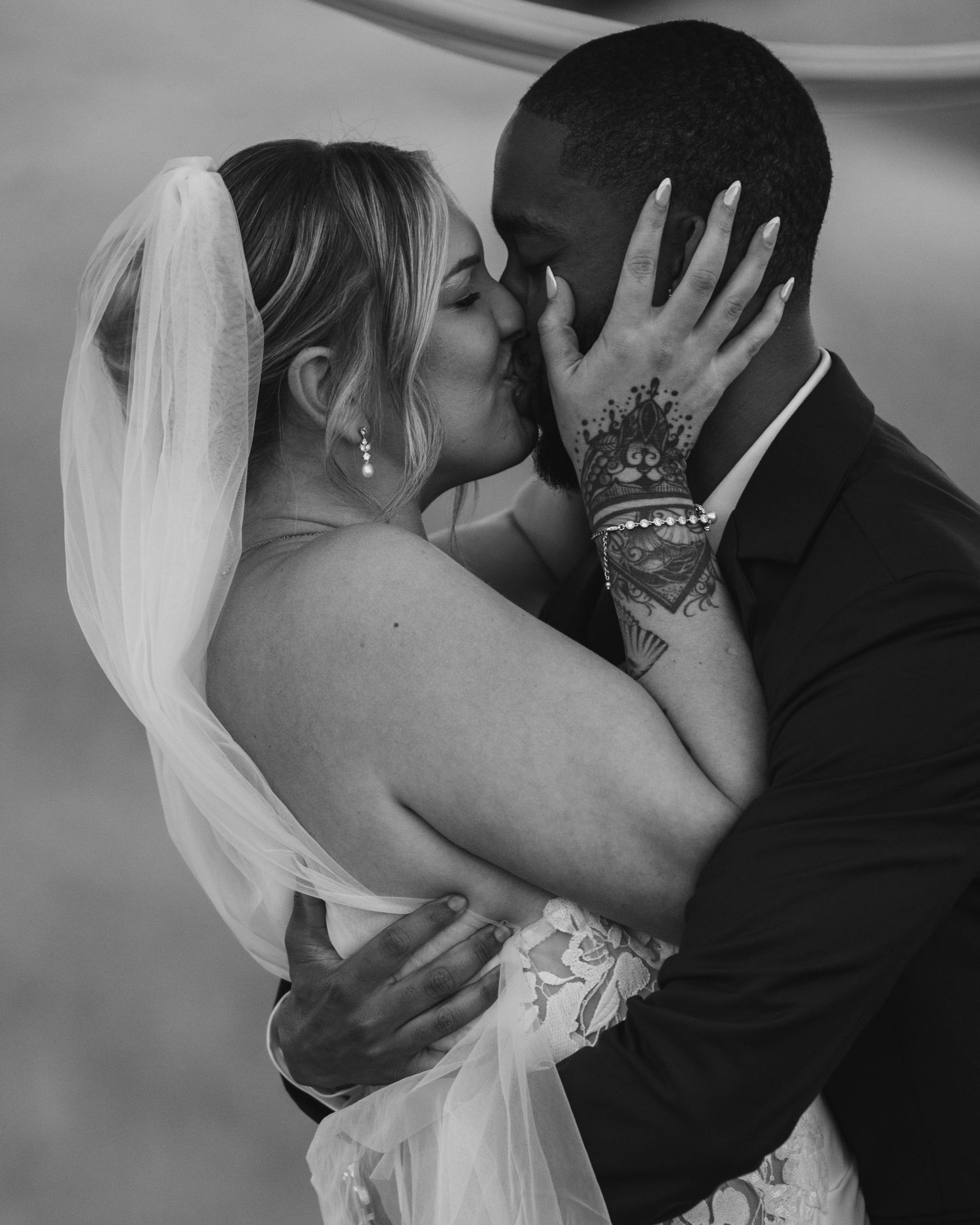 Black and white wedding portraits showing tender moments between newlyweds.