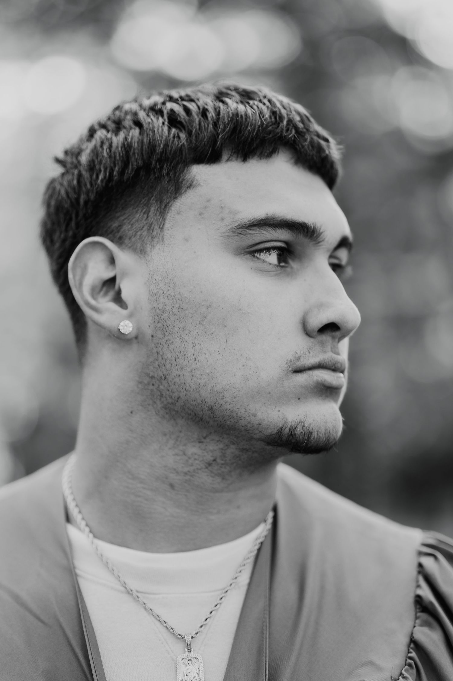 Series of black and white profile shots showing a person wearing a light colored shirt and necklace.
