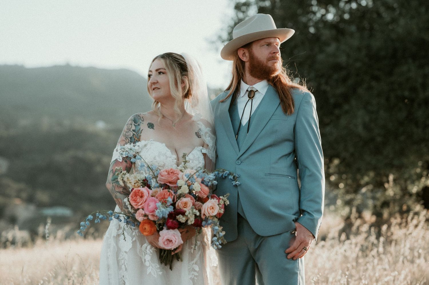 Romantic outdoor wedding photo shoot with coral and peach floral bouquet.
