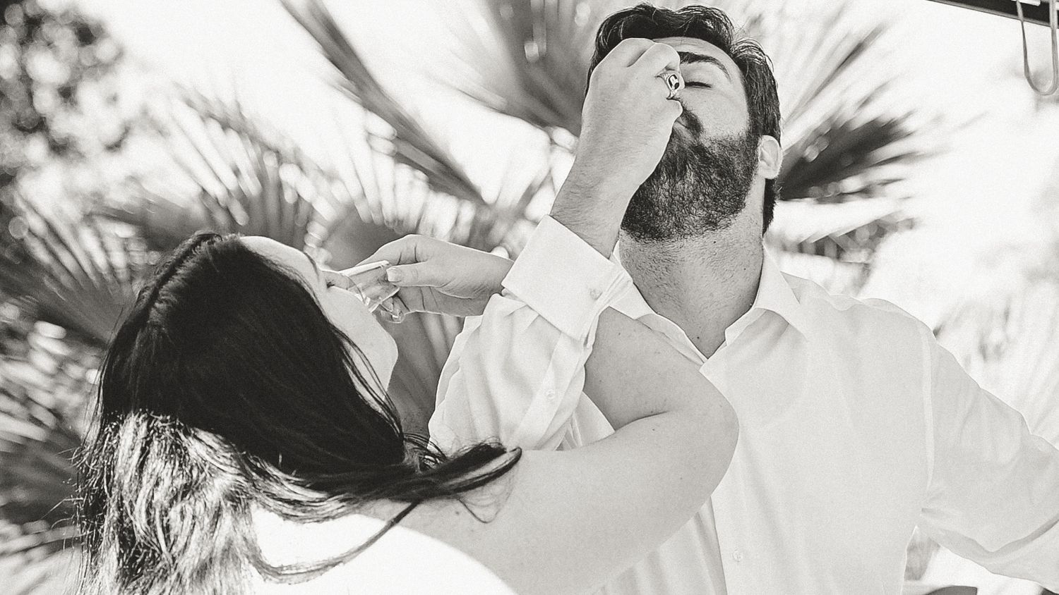 Black and white candid shot of people sharing an emotional moment.