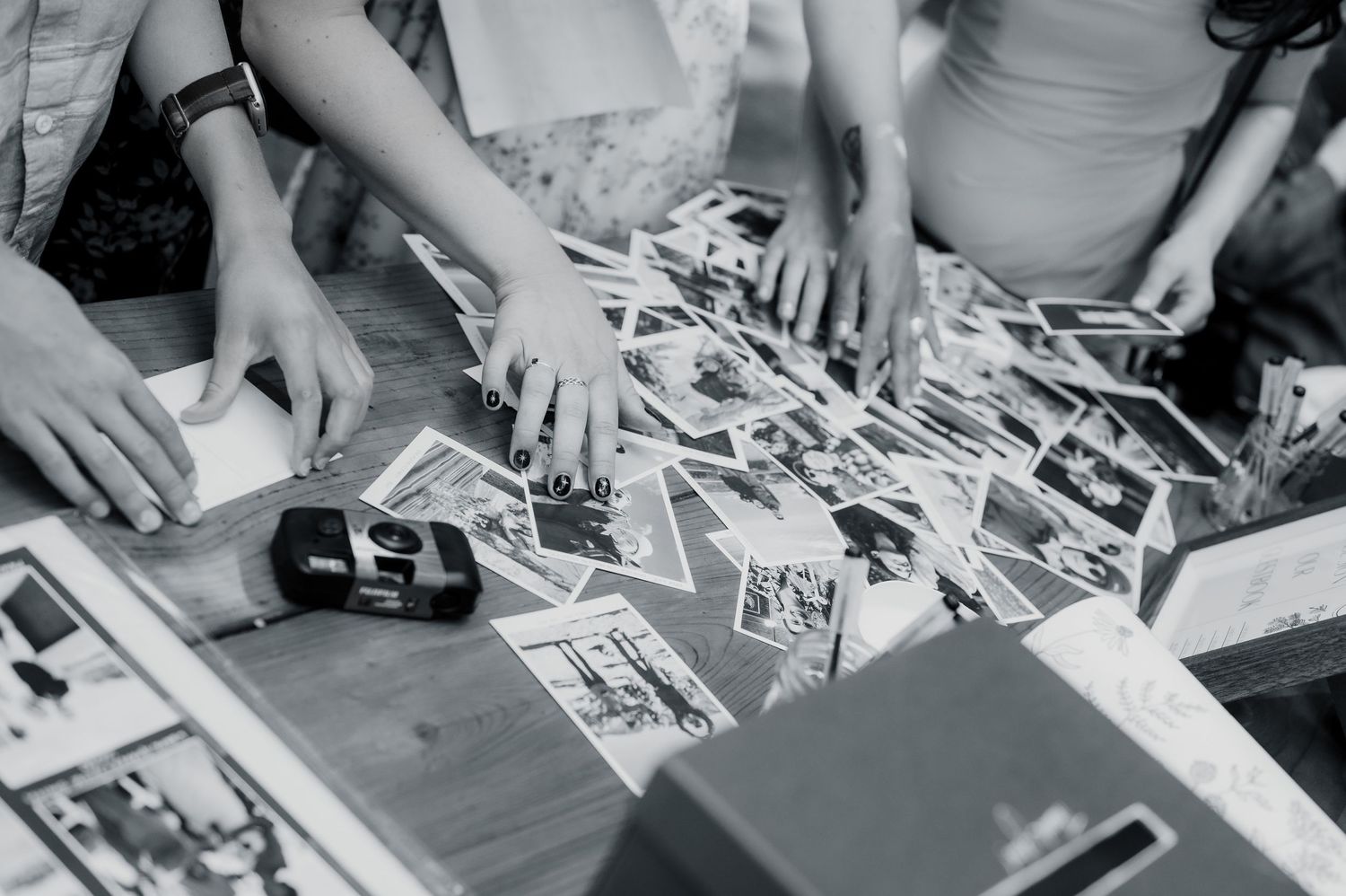 Overhead view of hands working with paper and craft materials on a table during a creative workshop session.