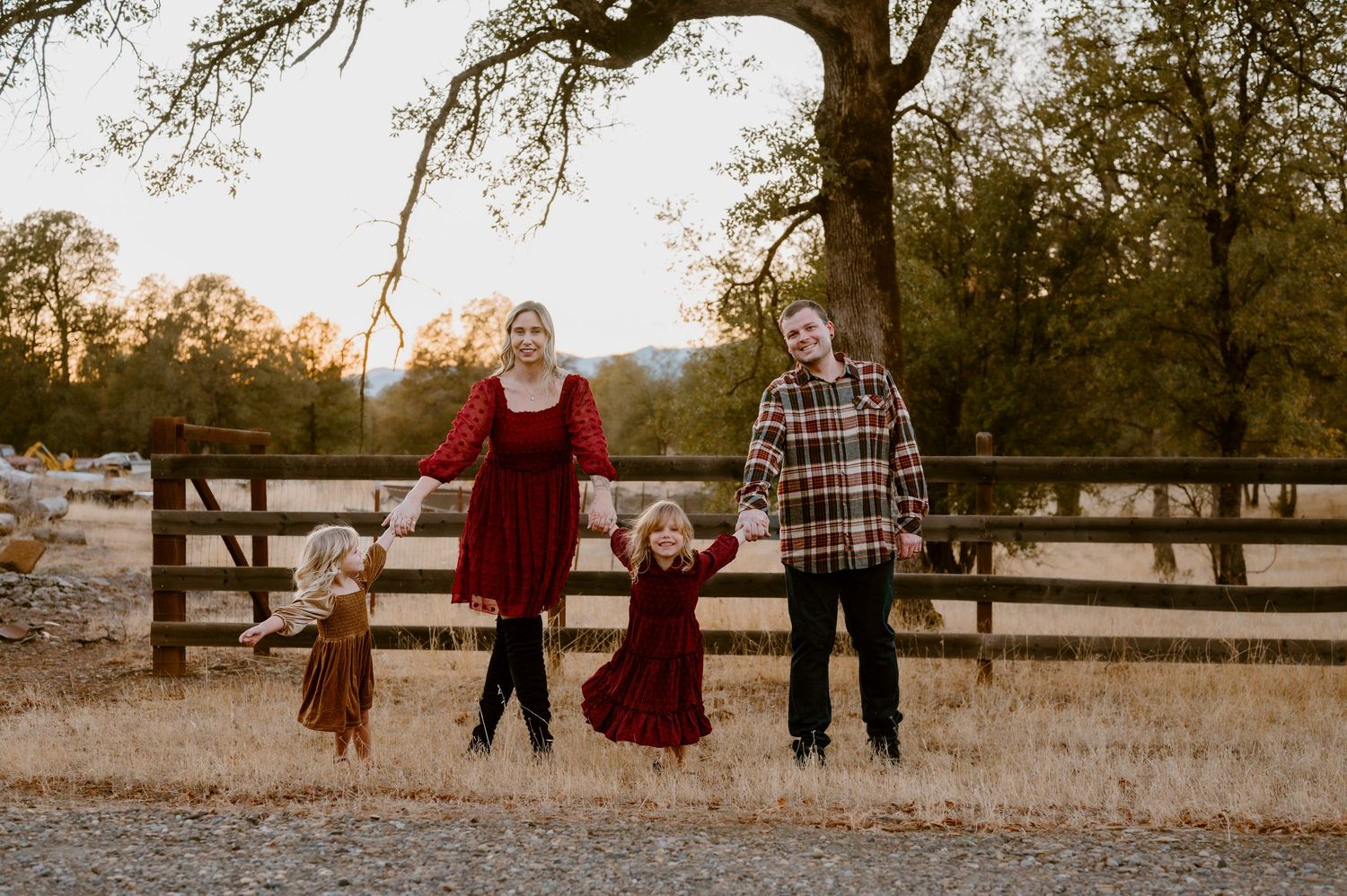 A series of outdoor family portraits at sunset in a rustic setting with wooden fences and autumn foliage.