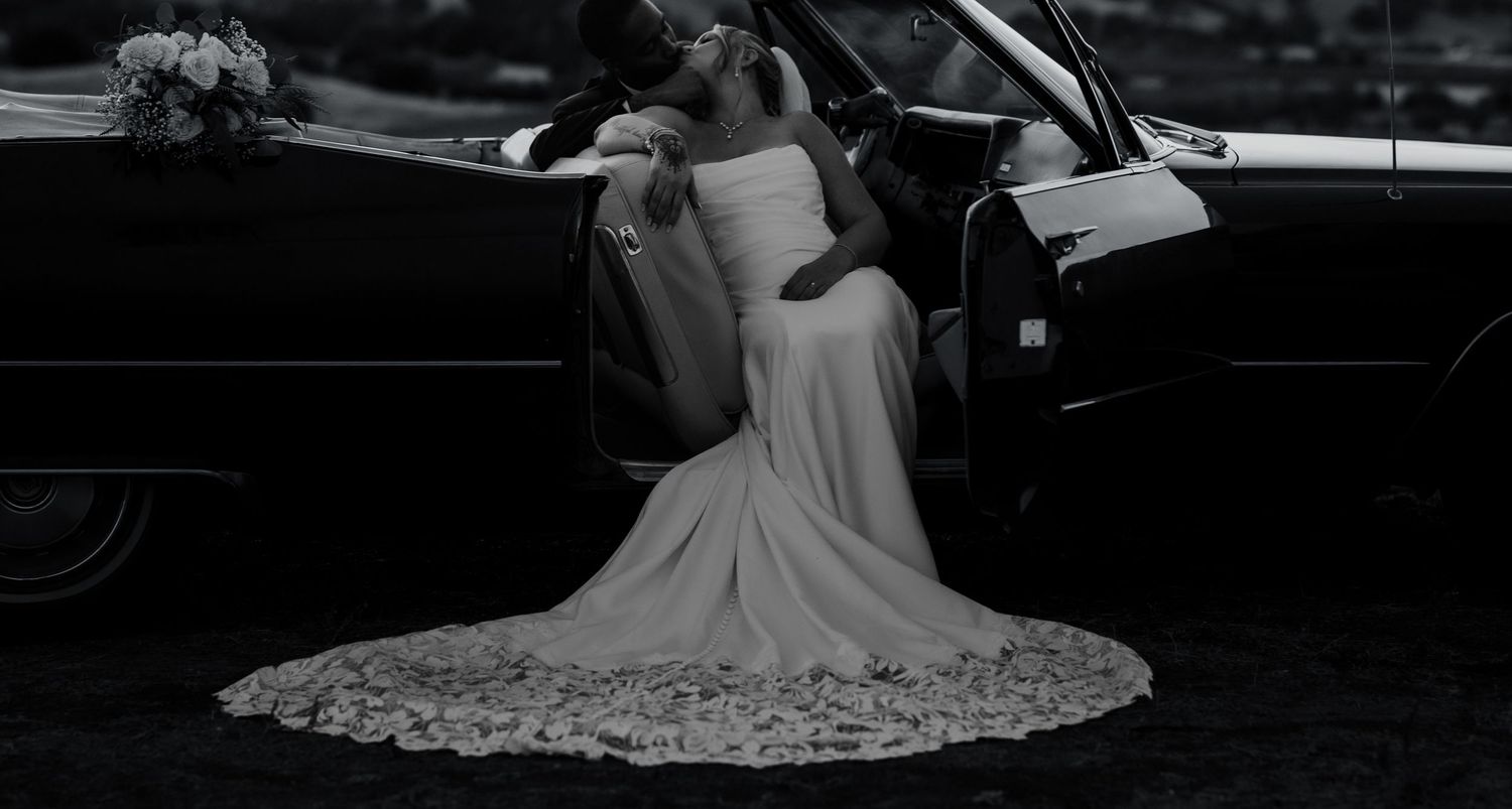 Black and white wedding photo series showing romantic moments and flowing dress details.