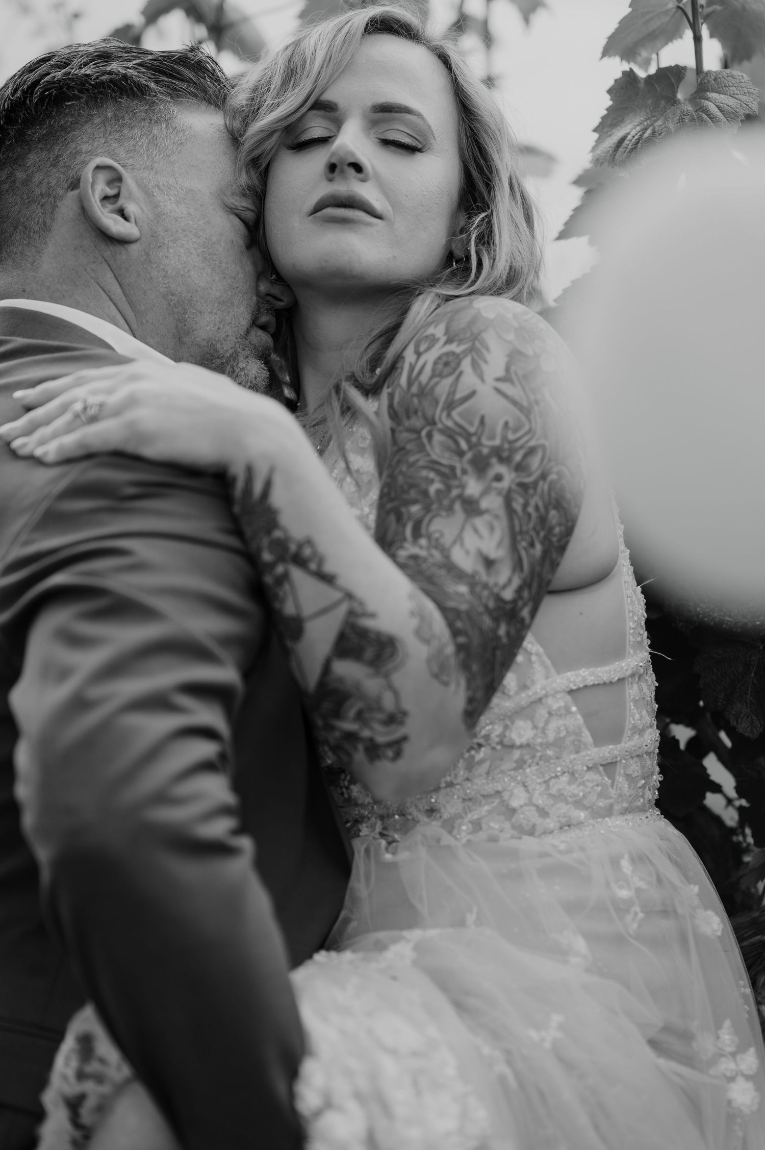 Intimate black and white wedding portrait showing tender embrace.