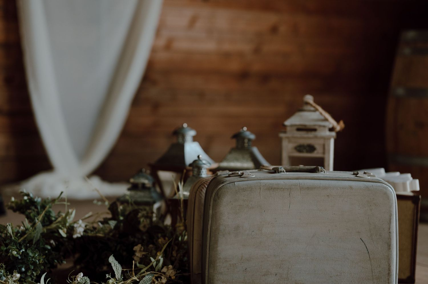 Vintage suitcase with miniature decorative elements on a wooden surface.