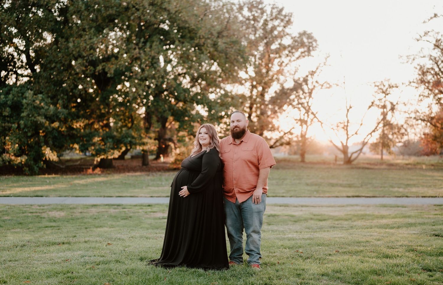 A series of sunset photos showing a couple sitting on grass at different angles during golden hour.