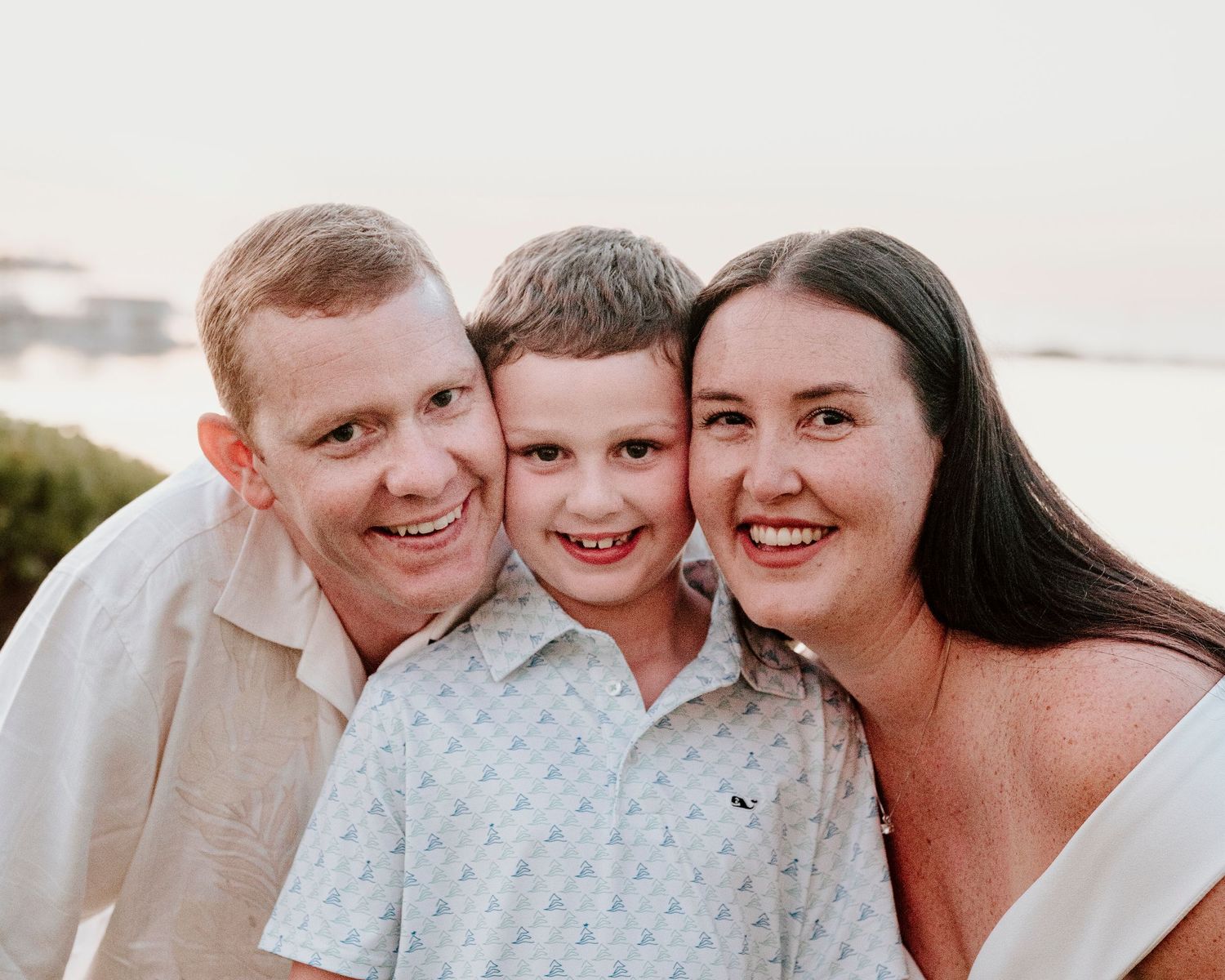 Heartwarming family portrait captured at sunset with warm smiles.