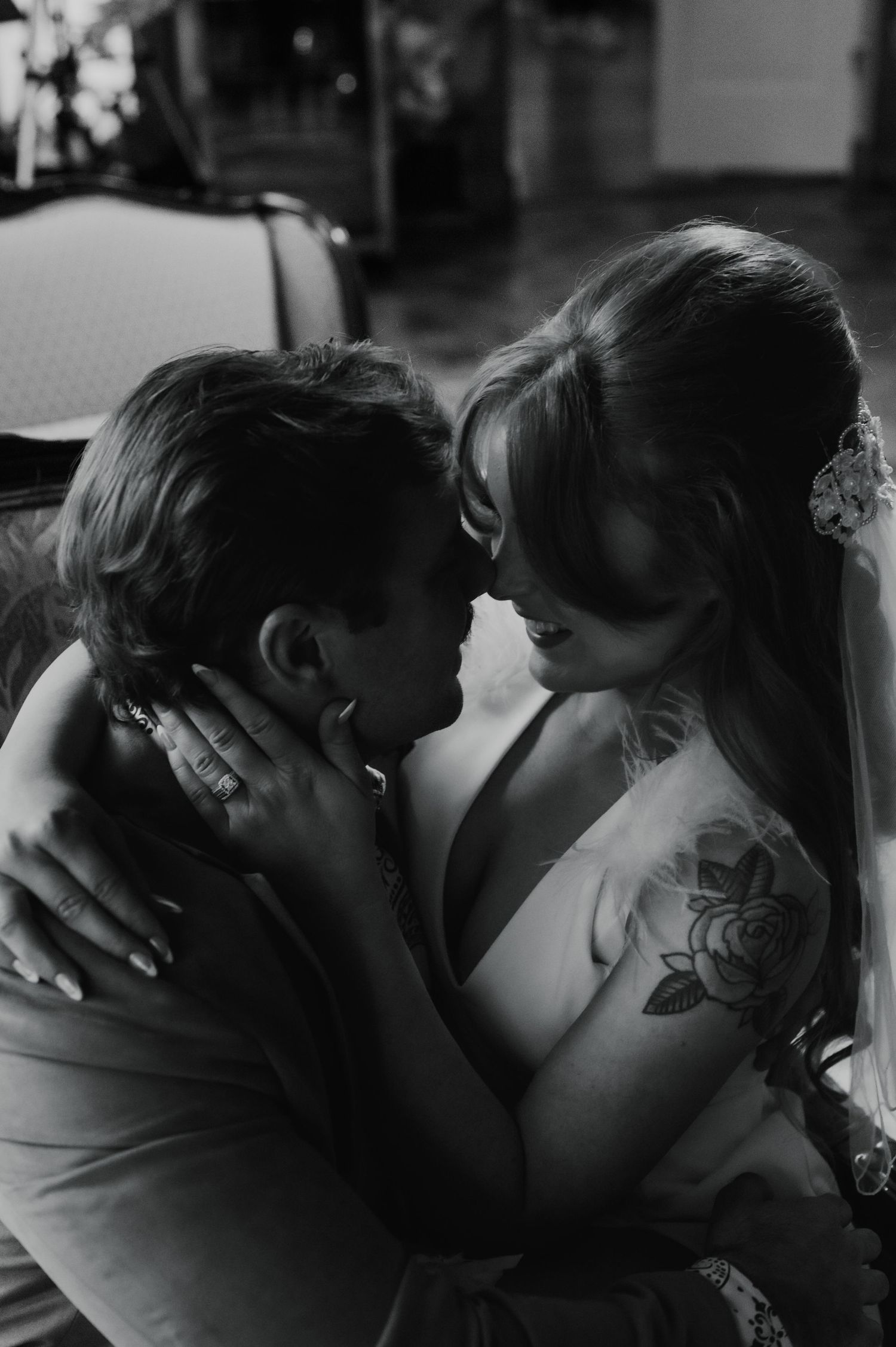 Black and white wedding portrait capturing a tender embrace between the couple.