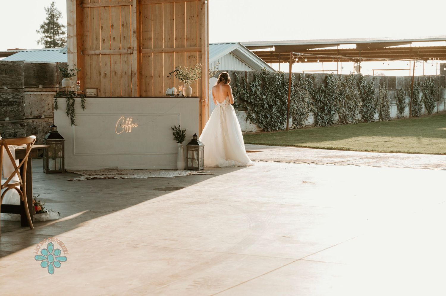 Outdoor wedding venue with wooden door and covered patio area.