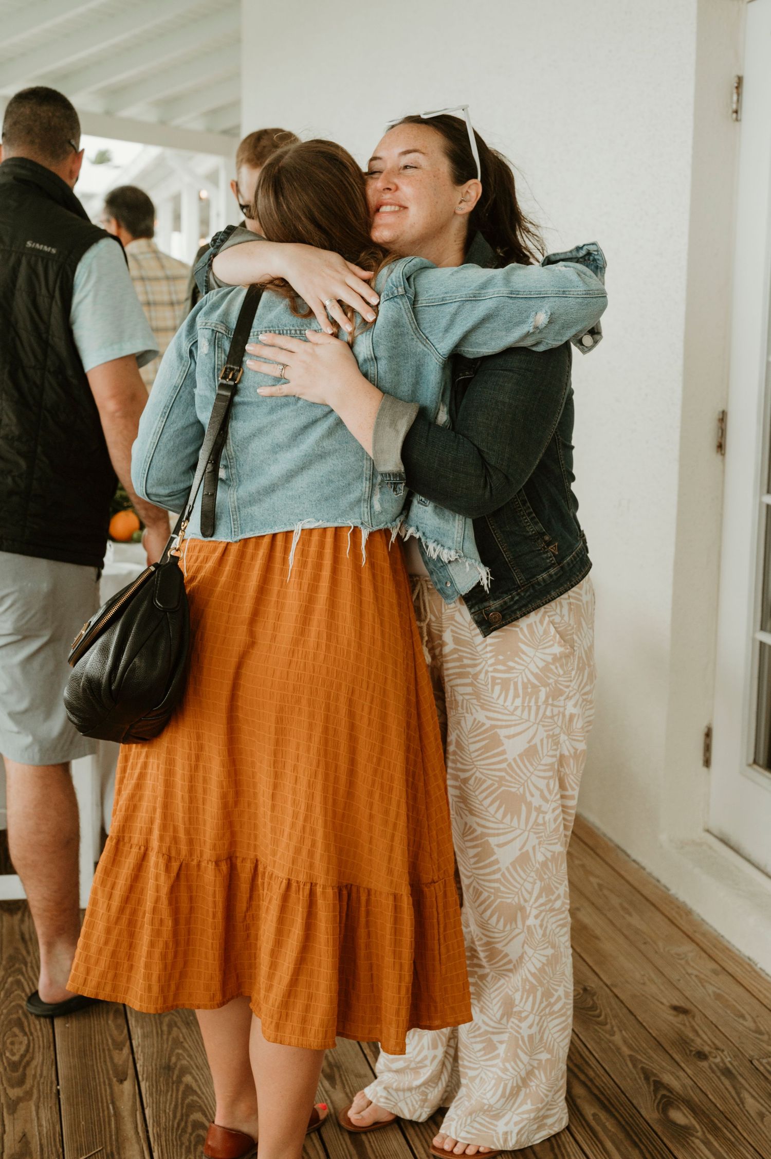 Two people sharing a warm embrace in casual attire.