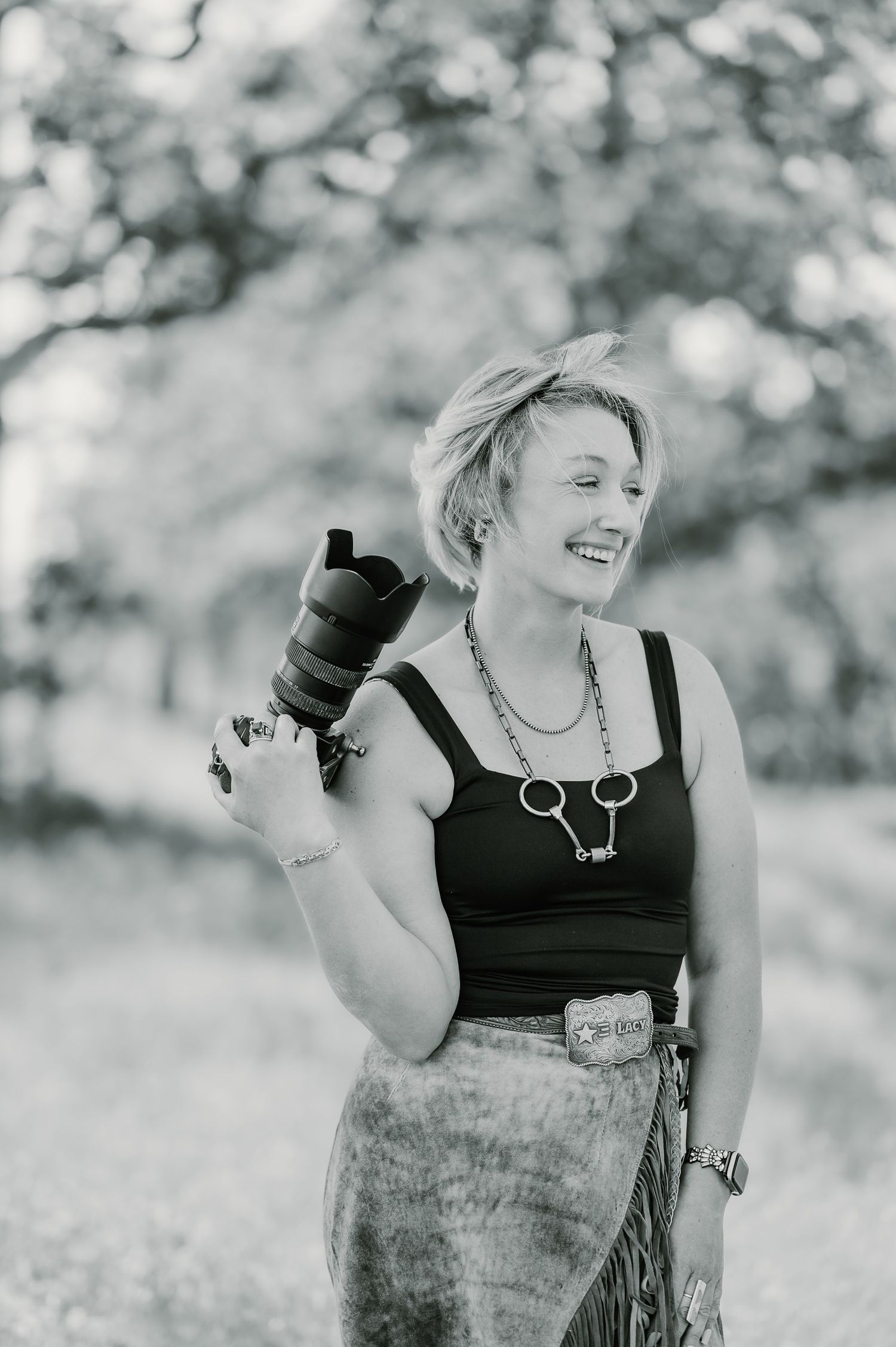 A sequence of black and white candid photos showing joyful laughter and natural expressions outdoors.