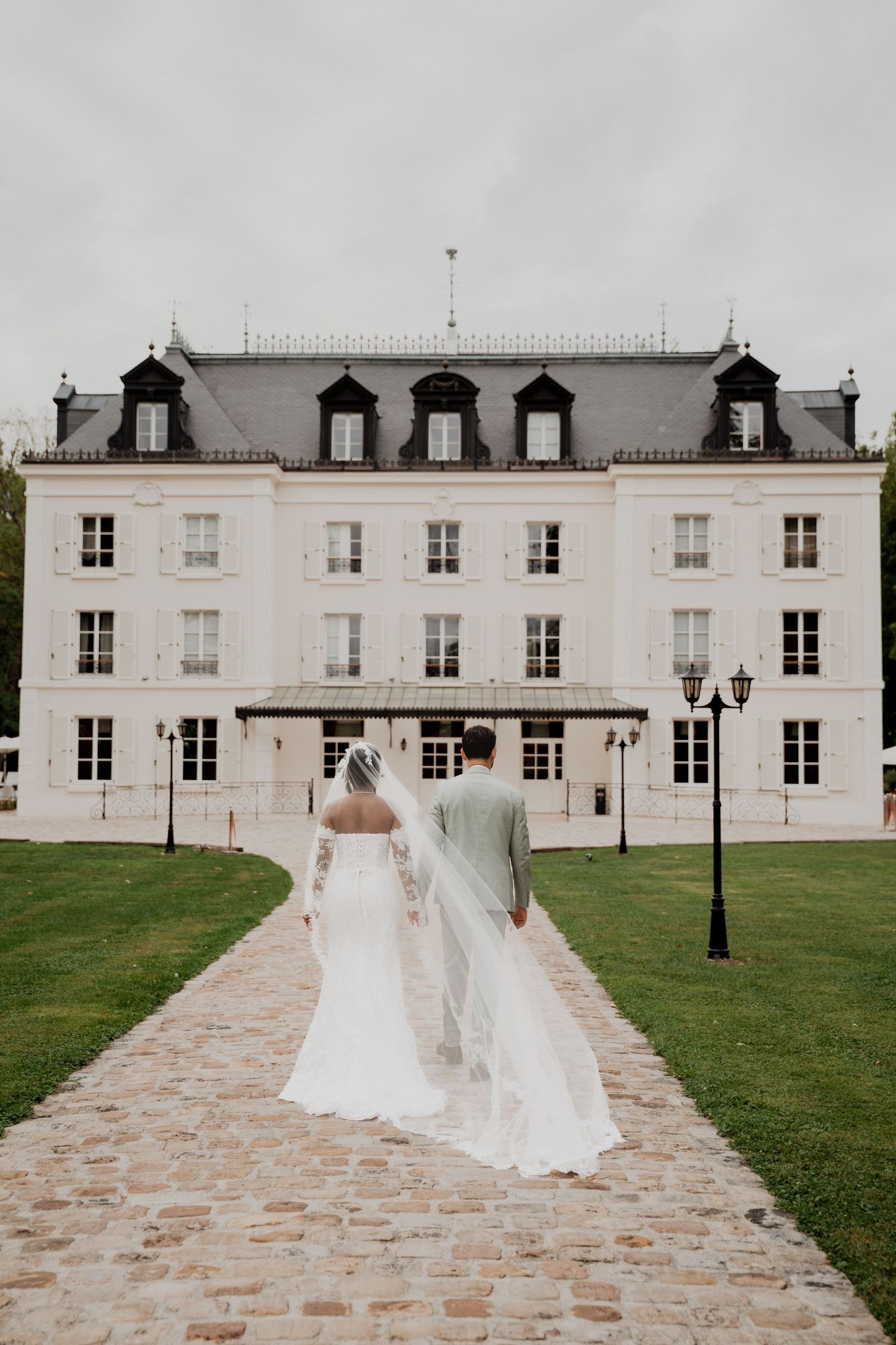 Elegant white mansion with classic architecture serves as stunning wedding venue backdrop.