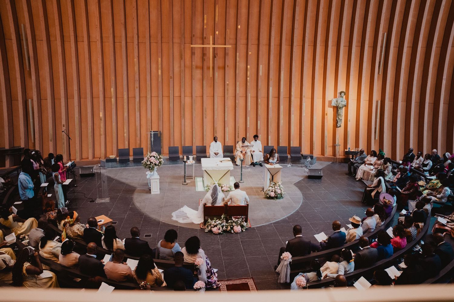 Aerial view of a circular stage performance with audience members seated in tiered seating.