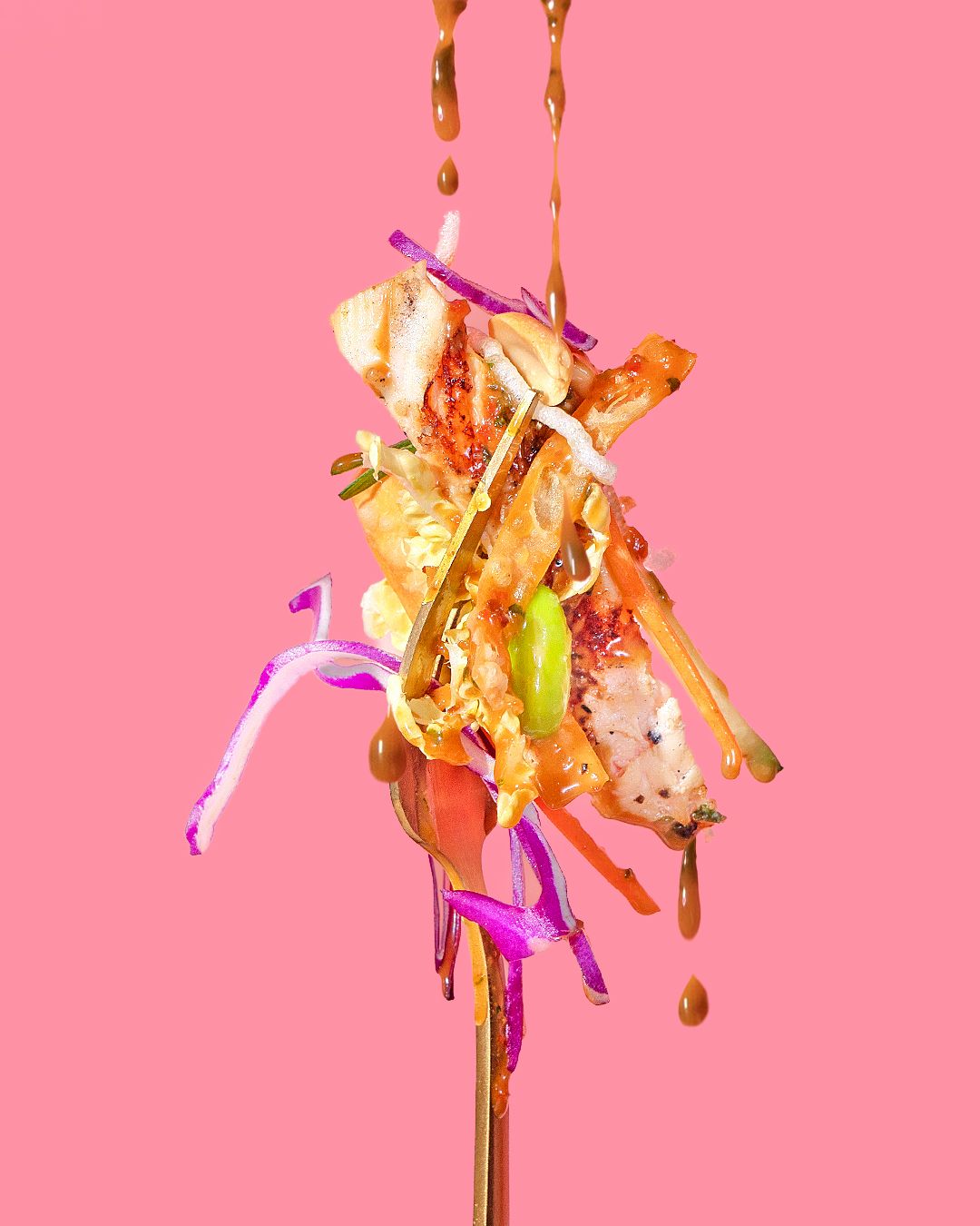 Colorful abstract food art with splashing liquid and vibrant pink background.