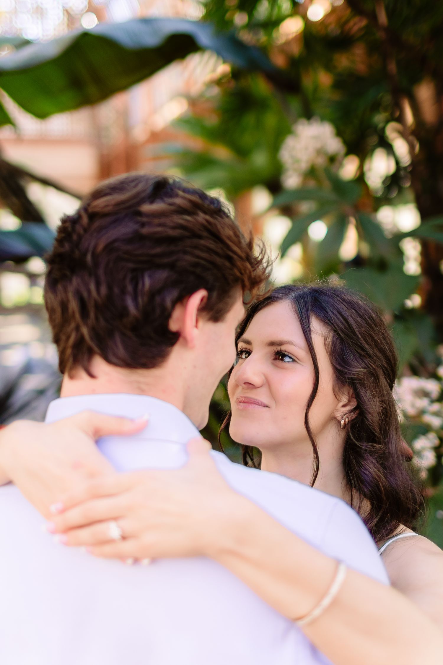 A couple shares an intimate moment while dancing outdoors.