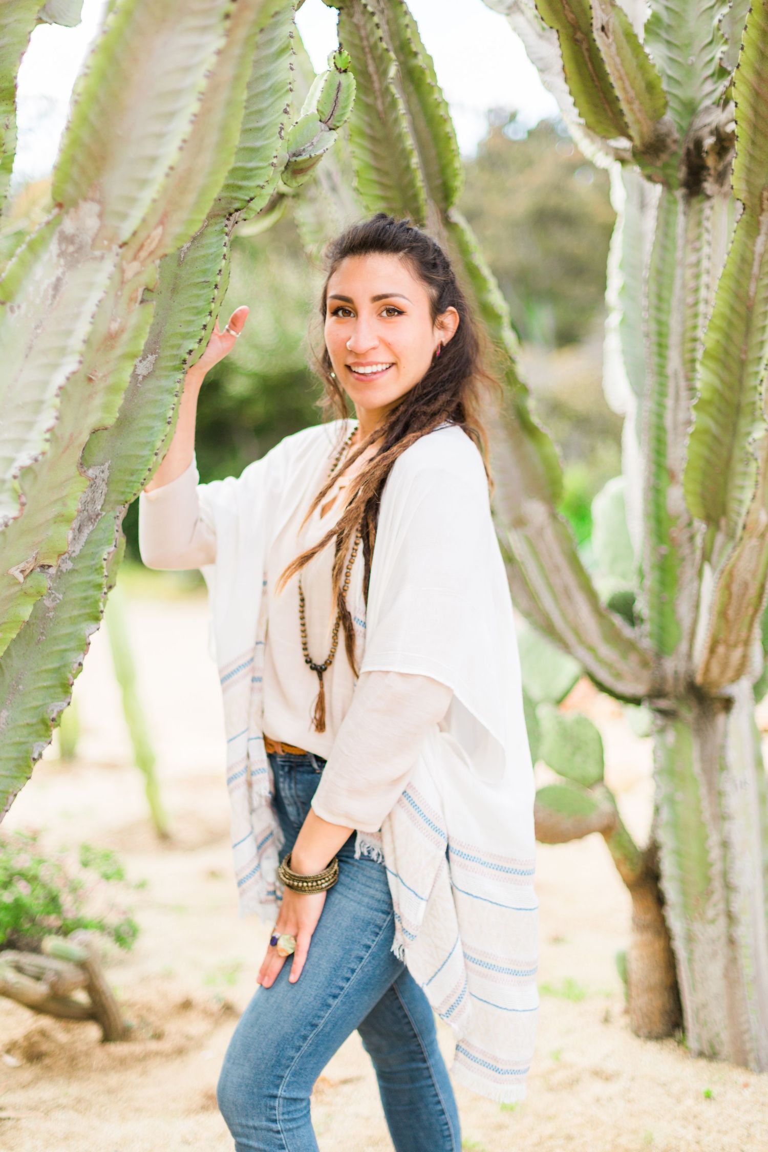 Casual lifestyle photos taken among tall cactus plants in a desert setting.