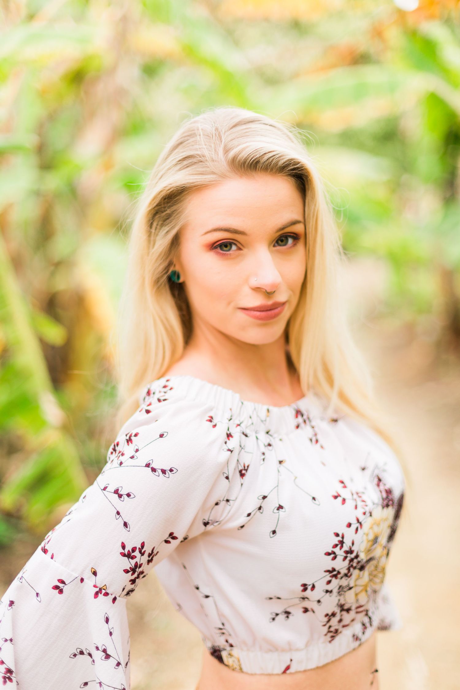 Spring portrait session featuring delicate cherry blossom styling and soft natural lighting.