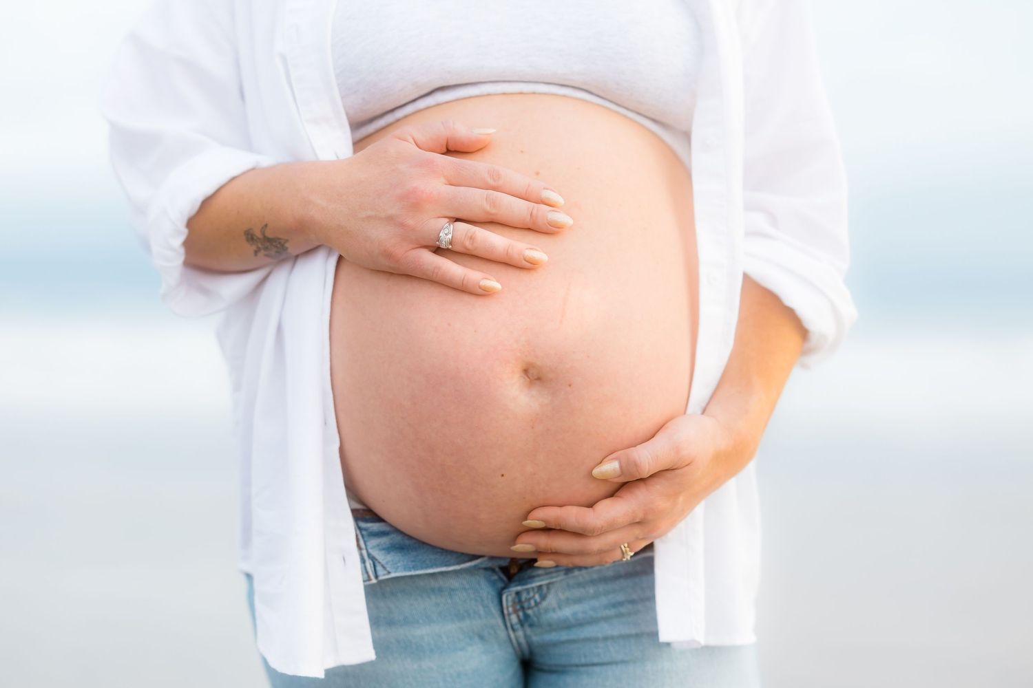 Close-up shots highlighting an expectant mother's baby bump in natural light.