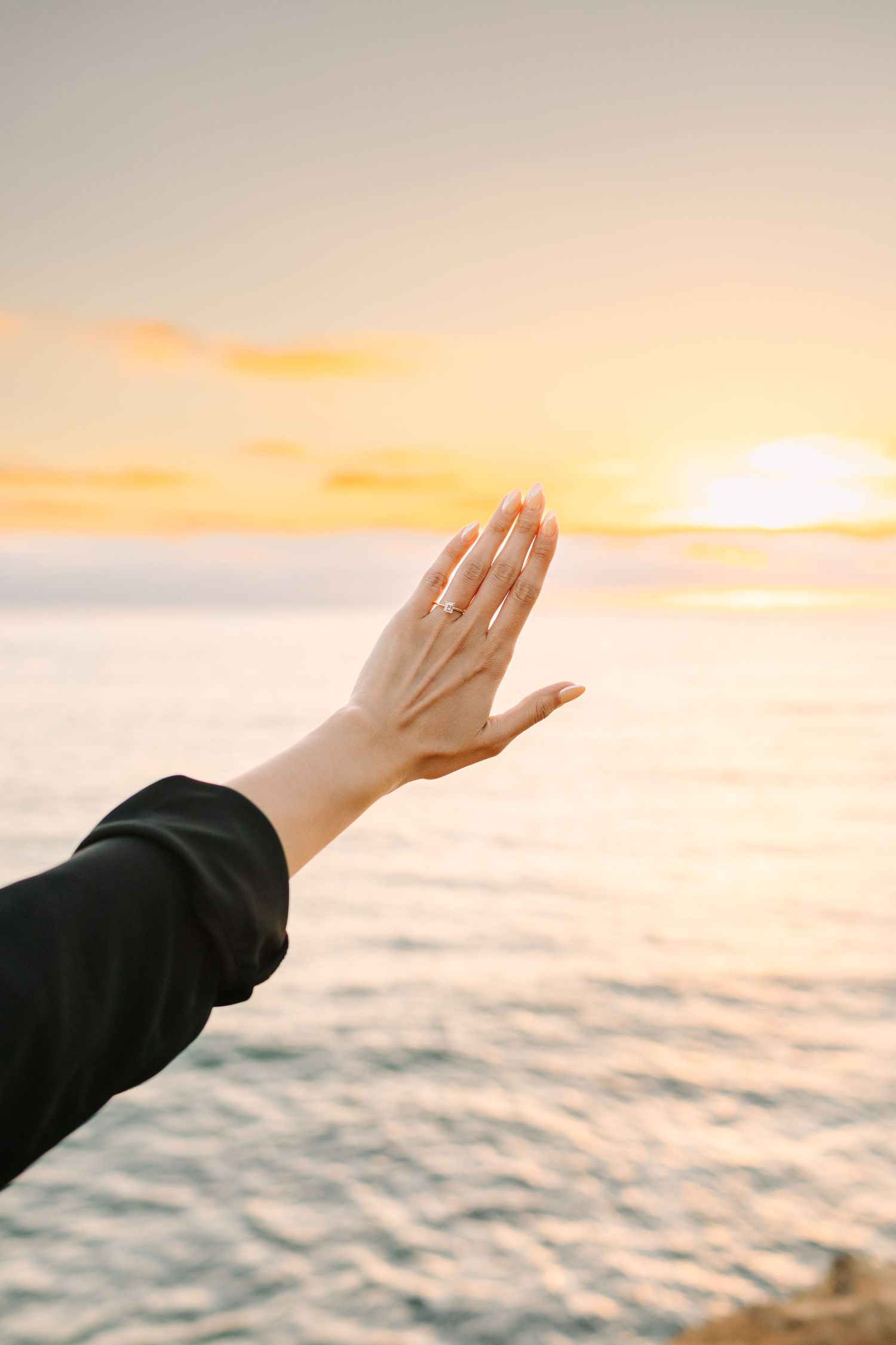 A hand reaches out towards a golden sunset over a tranquil ocean horizon in a series of peaceful images.