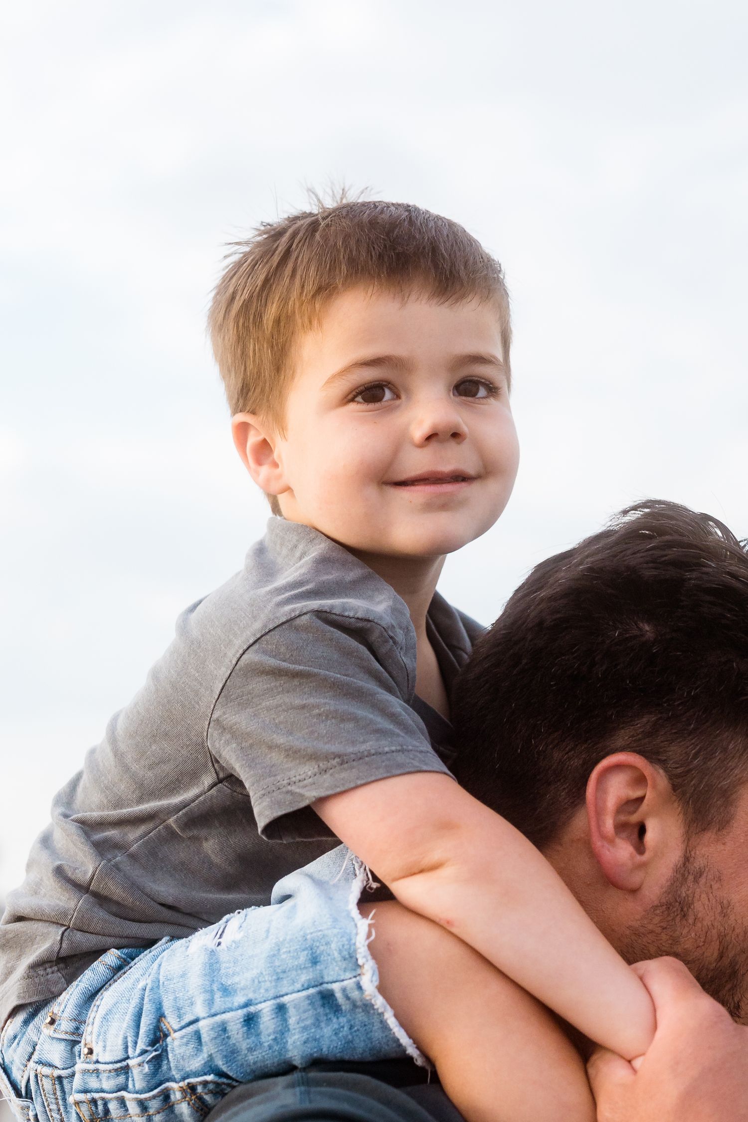 Close-up shots showing tender moments between parent and child at the beach.