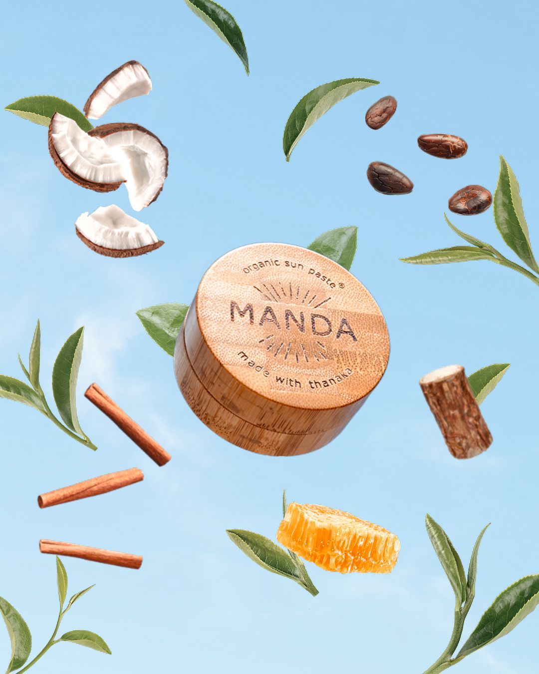 Natural skincare ingredients and Manda branded products floating on light blue background.