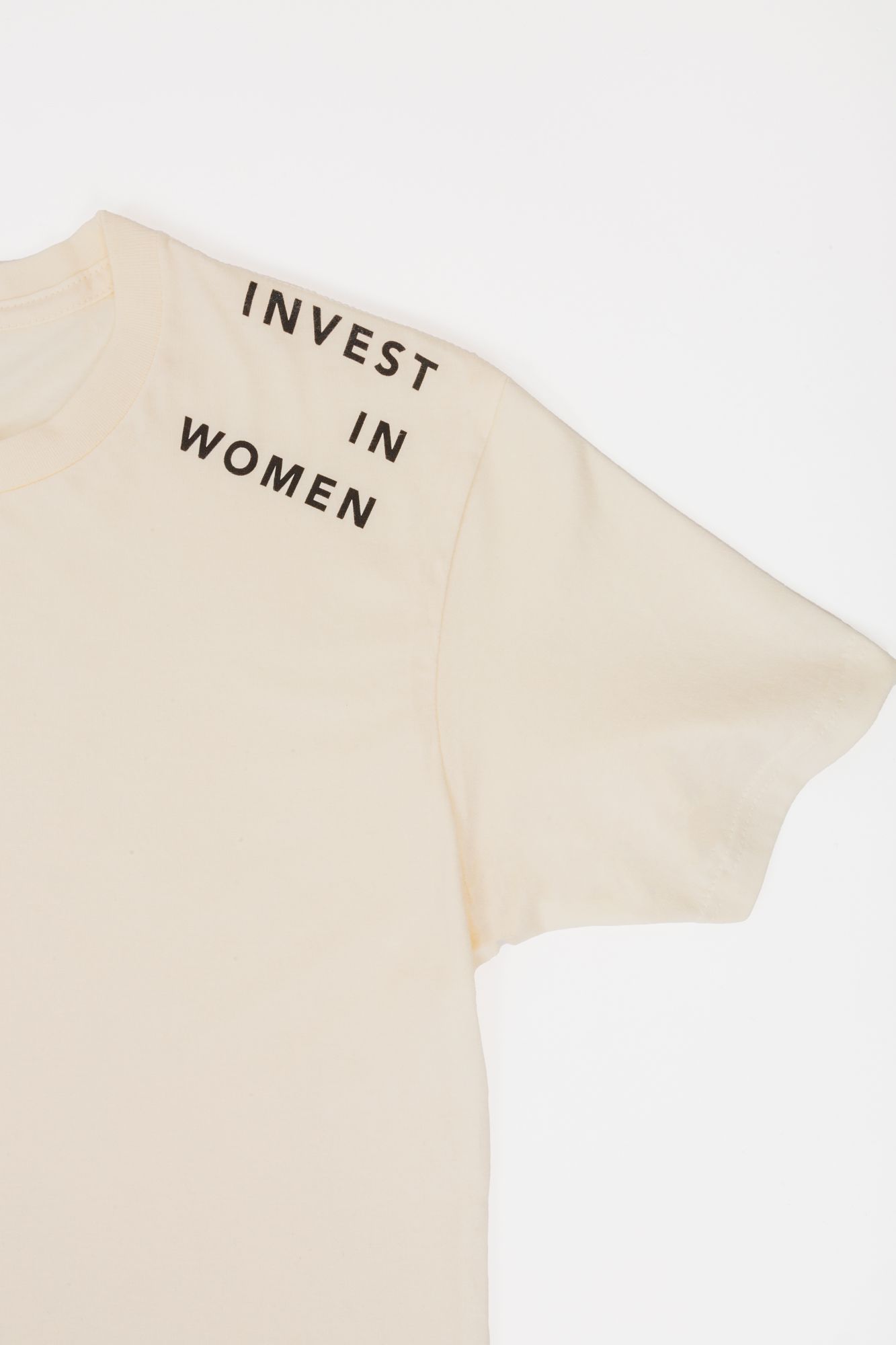 Beige t-shirt with 'INVEST IN WOMEN' text printed on shoulder area.