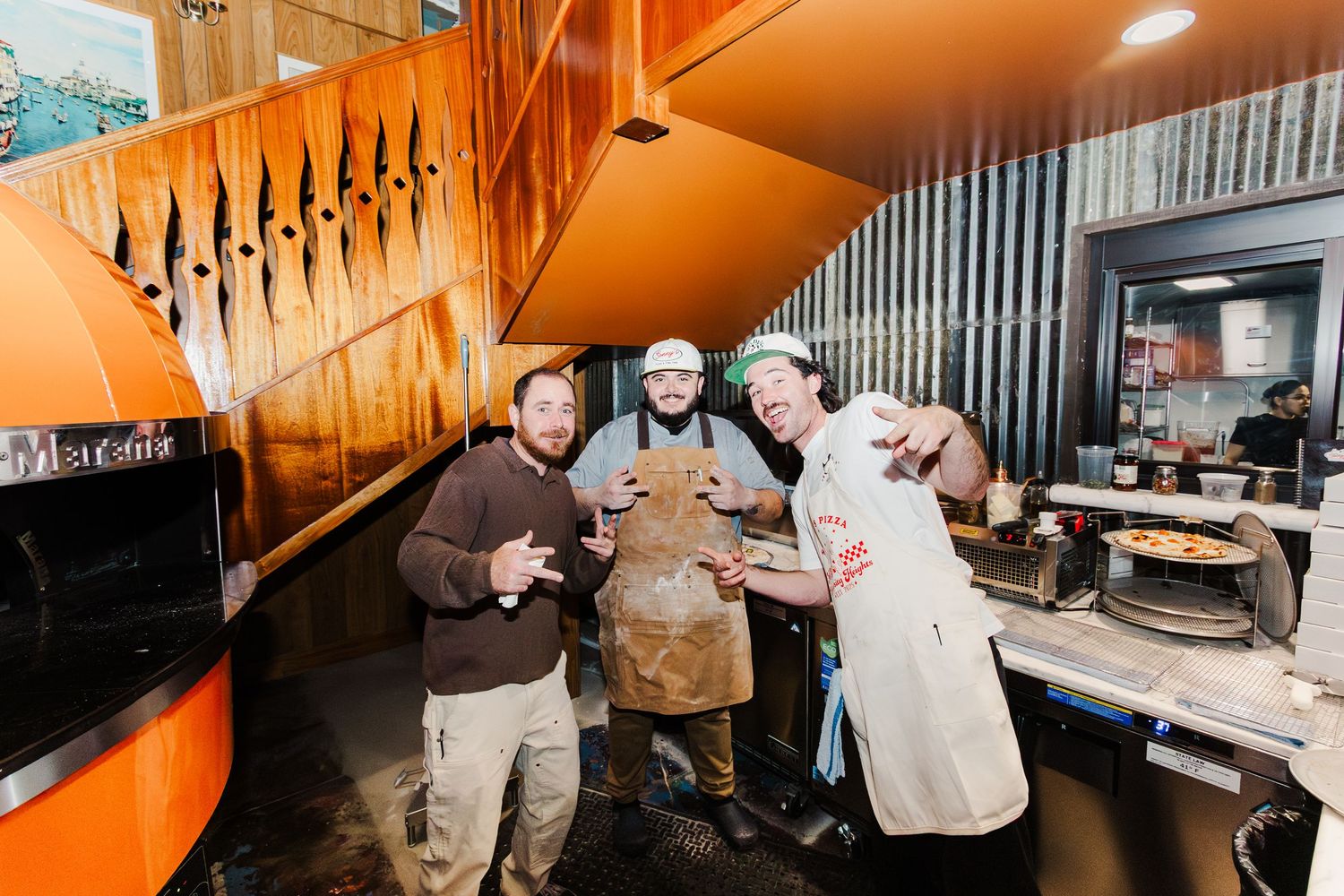 Friends enjoying drinks together at a cozy bar with warm lighting and wooden interior decor.