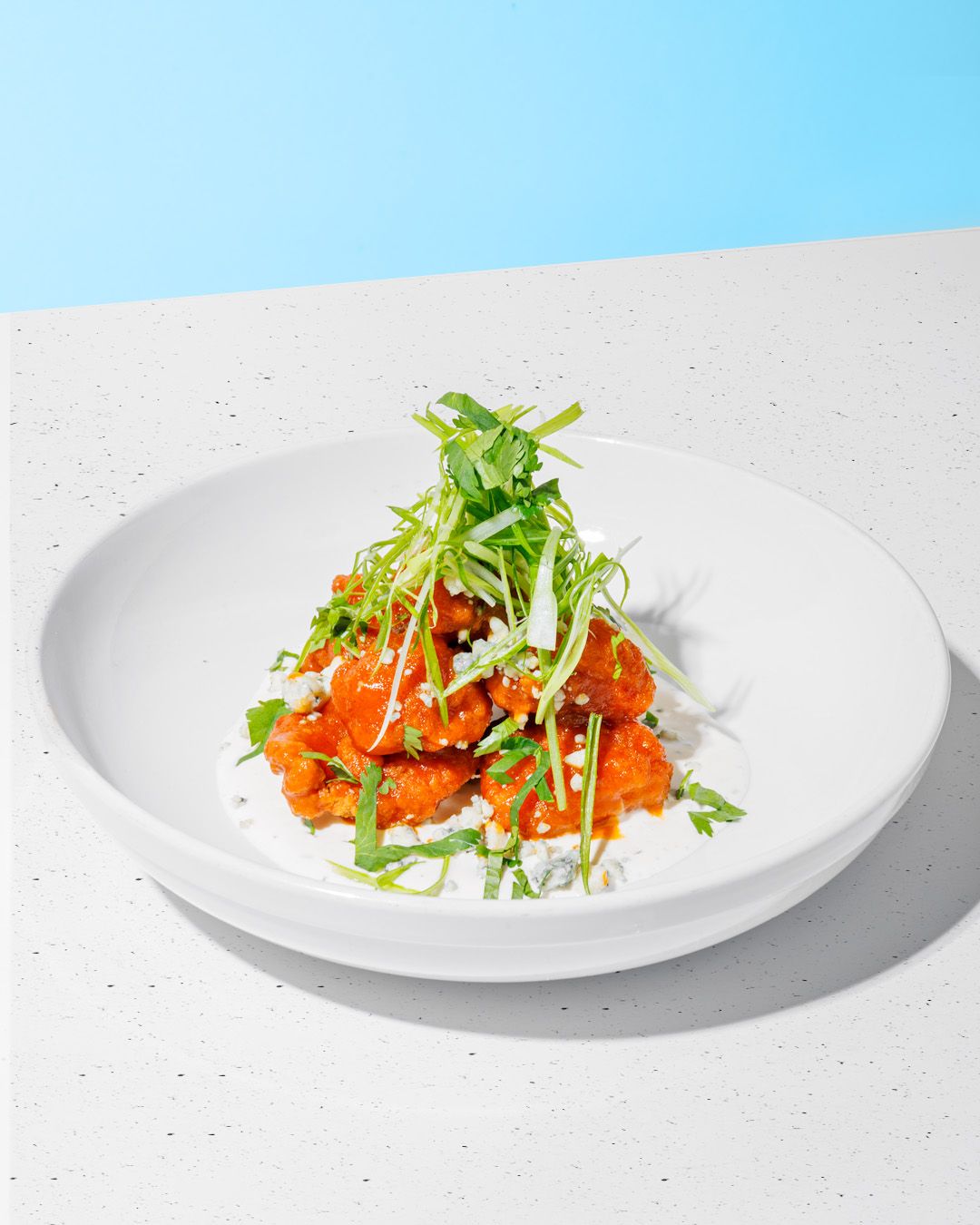 Fresh salmon sashimi dish with microgreens on white plates against clean backgrounds.