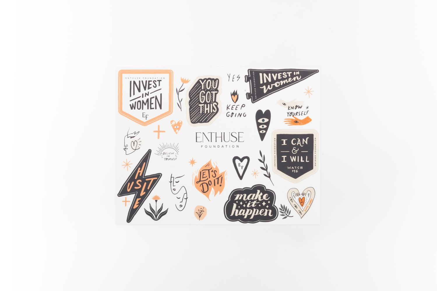 Collection of black and orange motivational stickers and badges with various inspirational phrases.