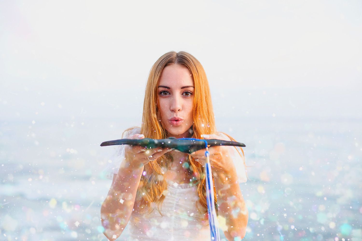 Winter portrait with falling snow and sparkling lights creating a magical atmosphere.