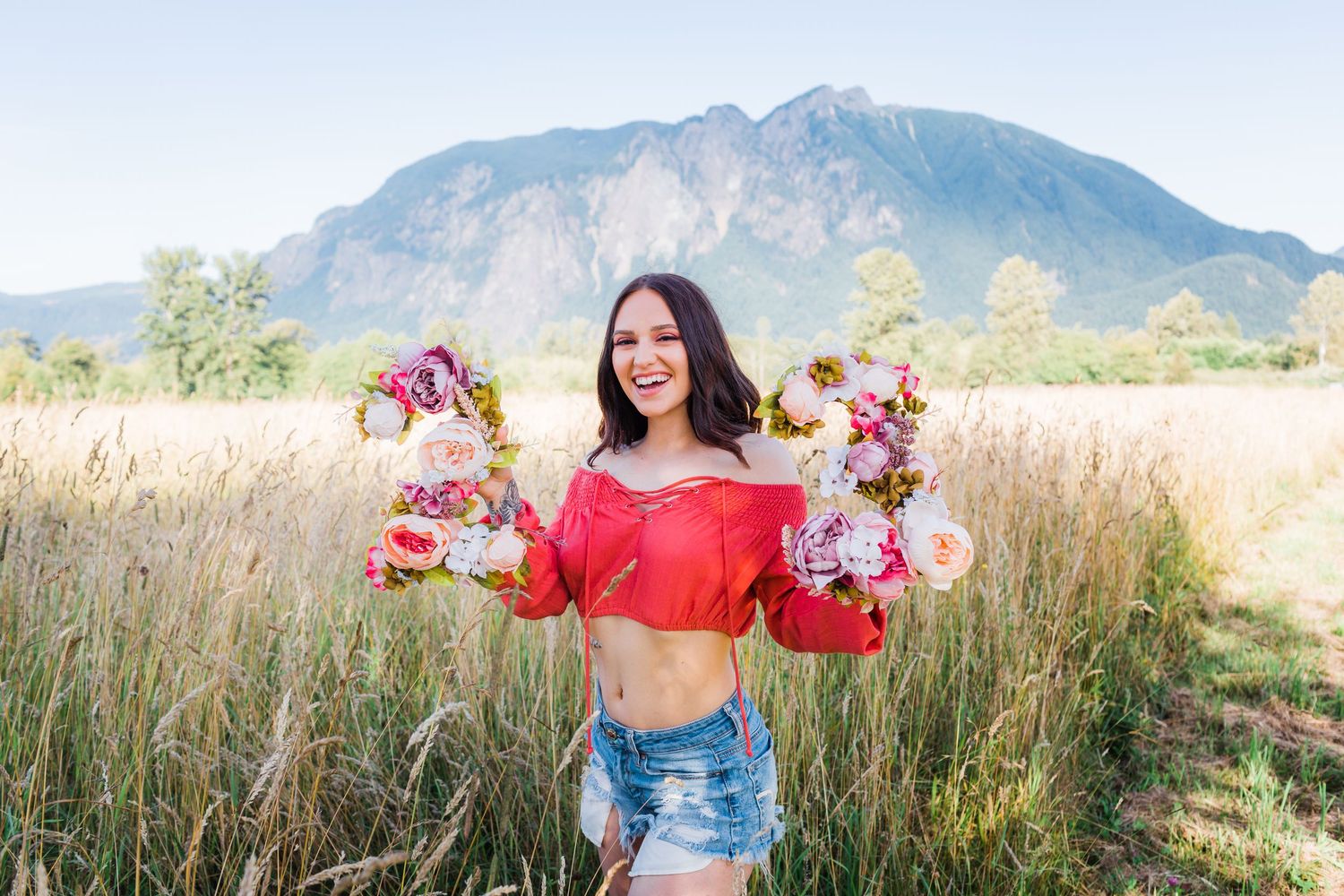 Wildflower meadow with mountain backdrop and scattered floral bouquets.