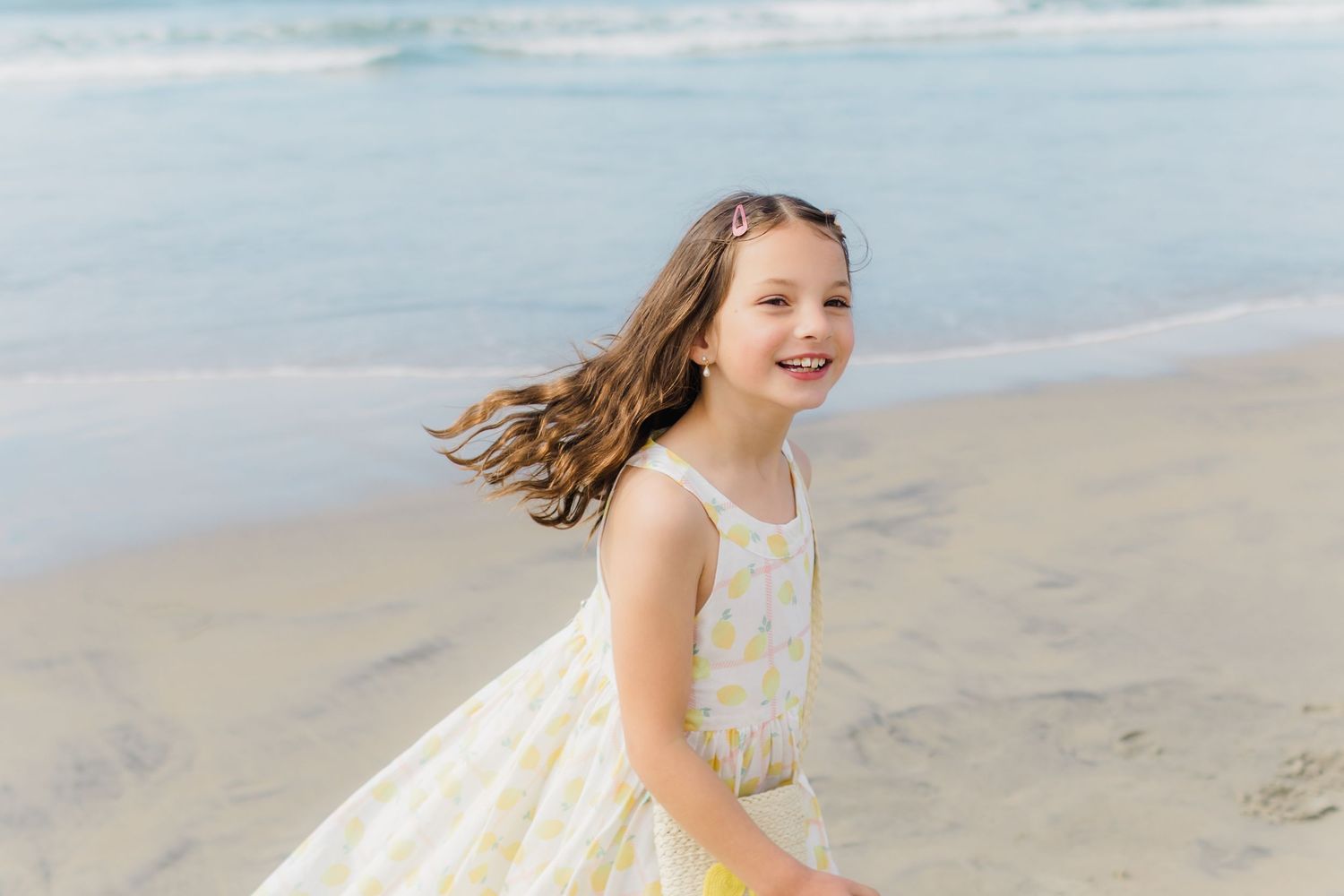 A series of photos showing someone running and playing joyfully along a sandy beach at sunset.