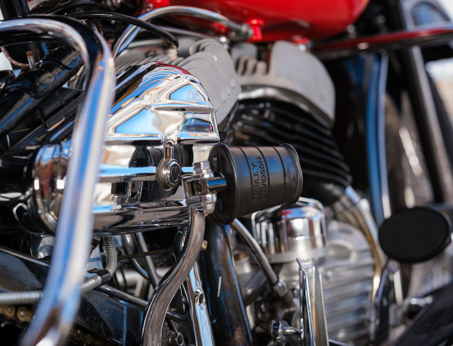 Closeup detail of a motorcycle engine showing chrome parts and mechanical components.
