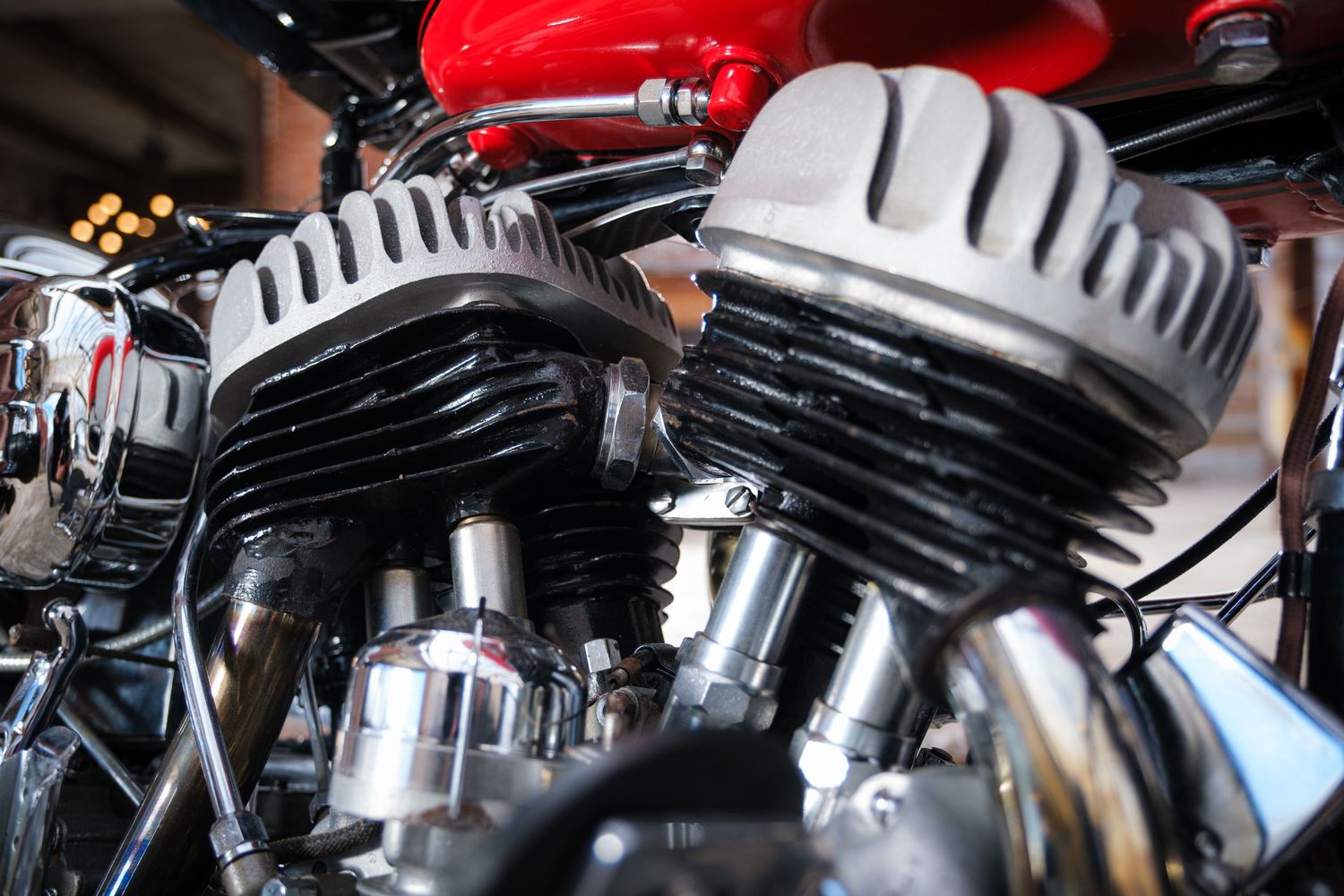 Close-up detail of a chrome motorcycle engine showing intake and cooling fins.